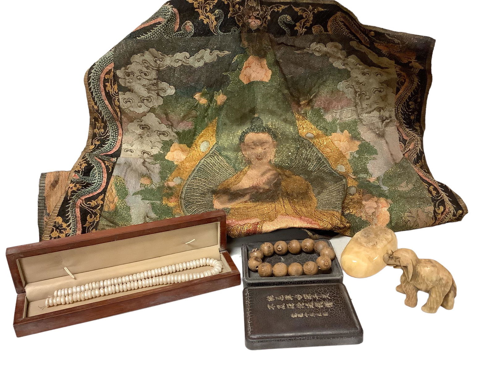 Group of Asian items including a soapstone carved elephant @ 2 1/2" tall, a wood ball bracelet in (1 of 3)