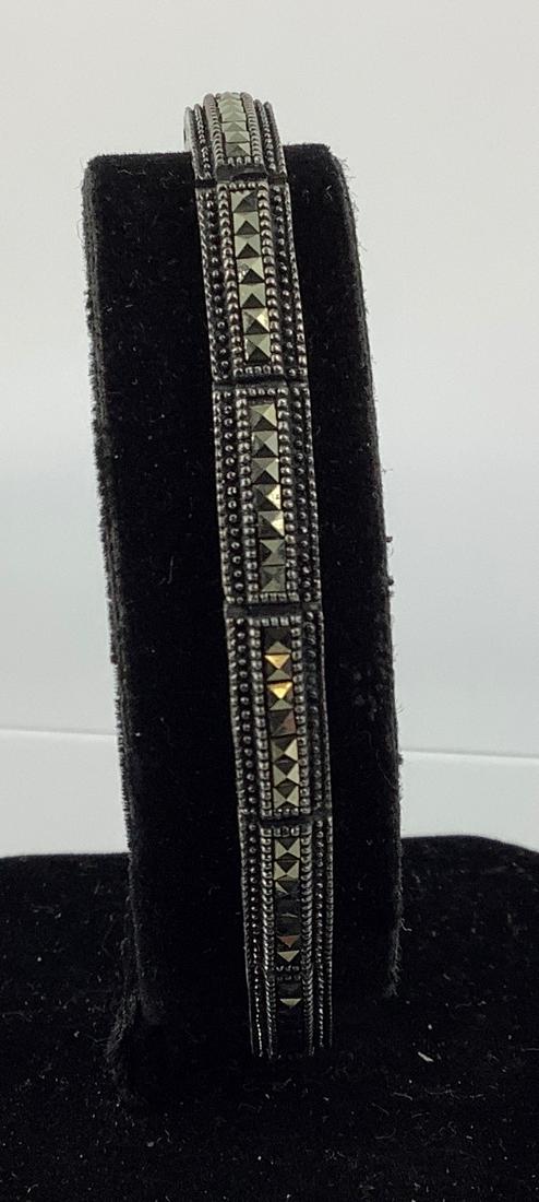 Sterling and Marcasite Stone Bracelet: Sterling and Marcasite Stone Bracelet Stamped 925, signed "ATI", 7.125" in length, 5.75mm in width, slide clasp closure, with marcasite/pyrite decoration. 0.51 troy ounces total weight.