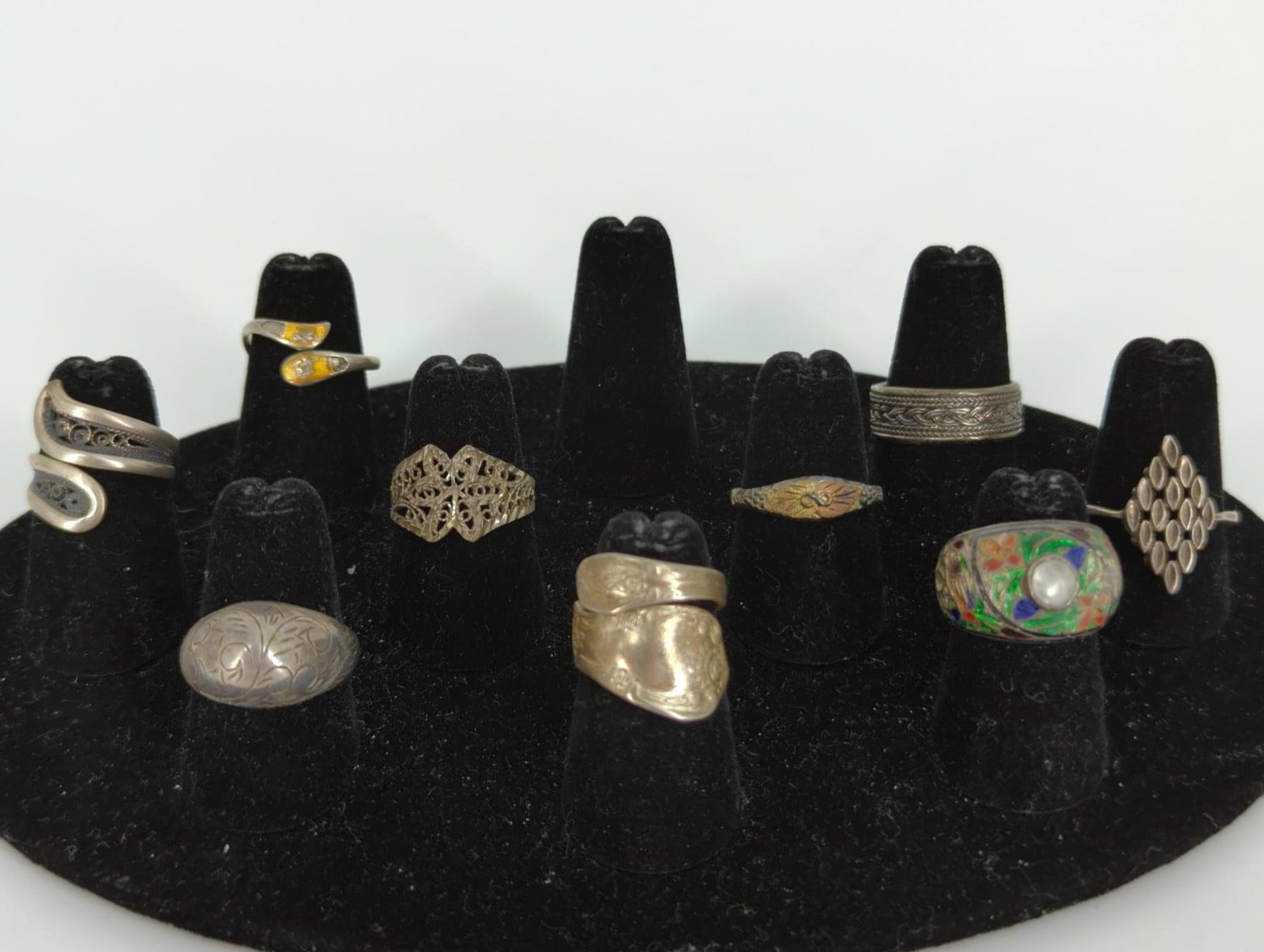 Nine Silver Rings: Nine Silver Rings Vintage and vintage-style designs, mixed conditions, 20.9 dwt., sizes 4.5 - 9. Designs including filigree/openwork, enameled with clear stone, woven motif, reformed spoon, nielloware