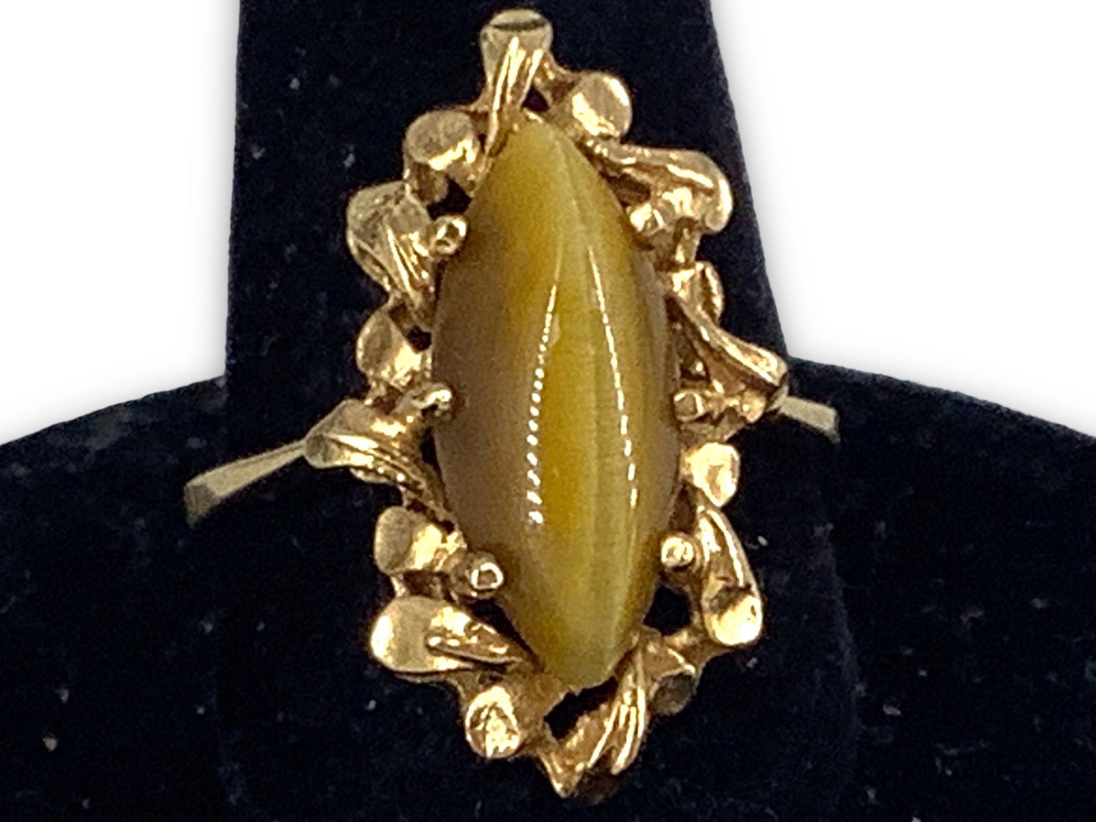 Vintage 14kt Gold and Tiger's Eye Stone Ring: Vintage 14kt Gold and Tiger's Eye Stone Ring Stamped, tested, and signed. 3.0 grams total weight, size 6.25 with reverse tapered shank, 15.0mm x 6.5mm tiger's eye stone cabochon at center, mounting ad