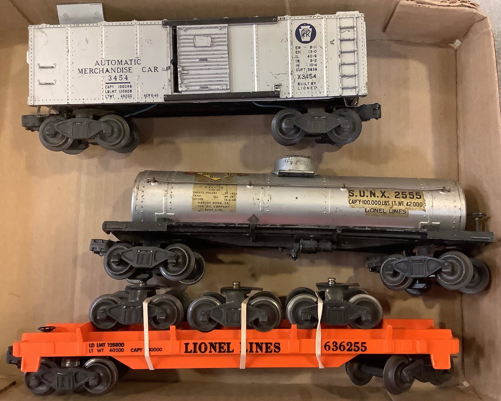 Lionel post war X3454 automatic merchandise car silver with blue lettering, 2555 Sunoco car 6362-55,: Lionel post war X3454 automatic merchandise car silver with blue lettering, 2555 Sunoco car 6362-55, truck car with 3 trucks.