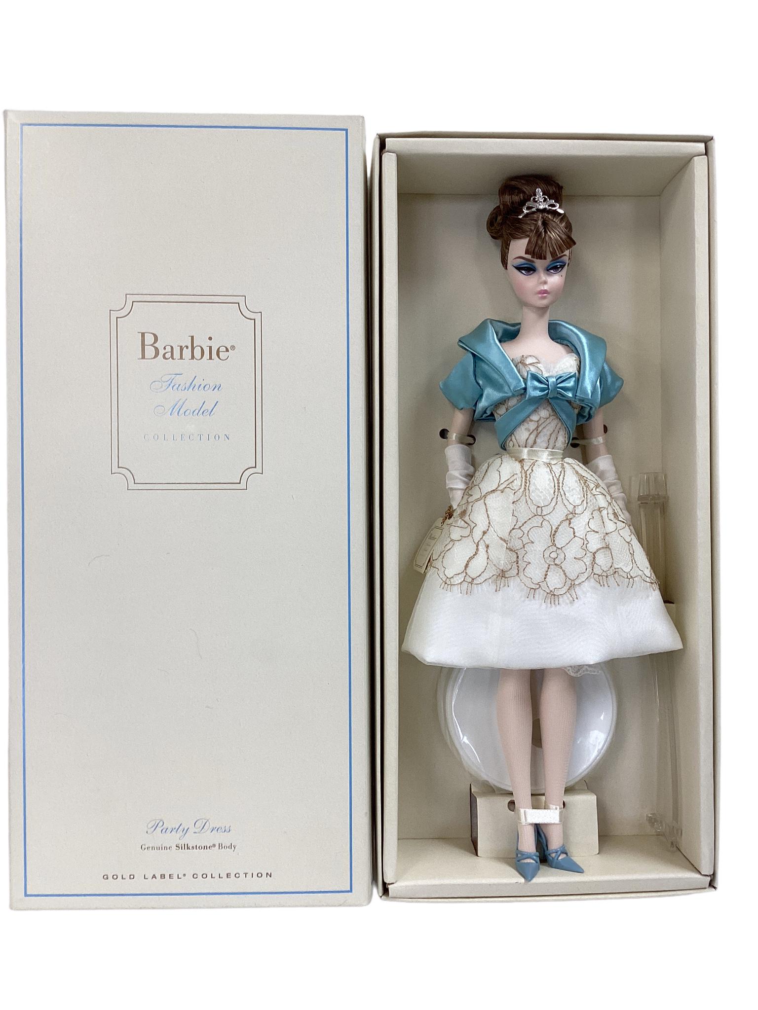 (1) BFMC PARTY DRESS BARBIE DOLL W/ SILKSTONE BODY. Barbie's ivory dress has a full-skirt silhouette: (1) BFMC PARTY DRESS BARBIE DOLL W/ SILKSTONE BODY. Barbie's ivory dress has a full-skirt silhouette & taupe lace overskirt, sash & bow & stiletto pumps matching her blue cropped jacket. opera gloves,