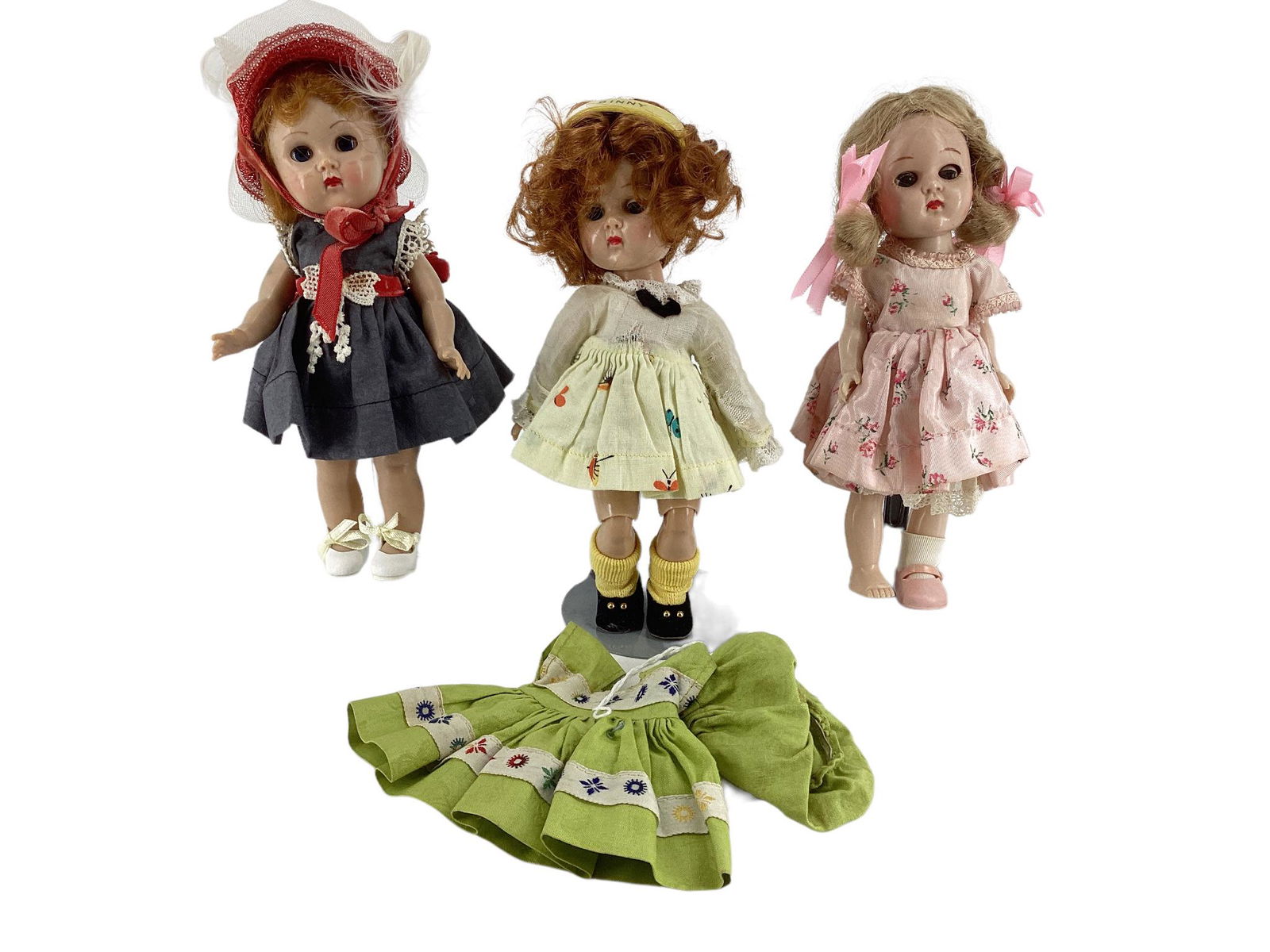 Lot of (3) 8" hard plastic Vogue Ginny dolls including blonde in pink tagged dress with molded (1 of 2)