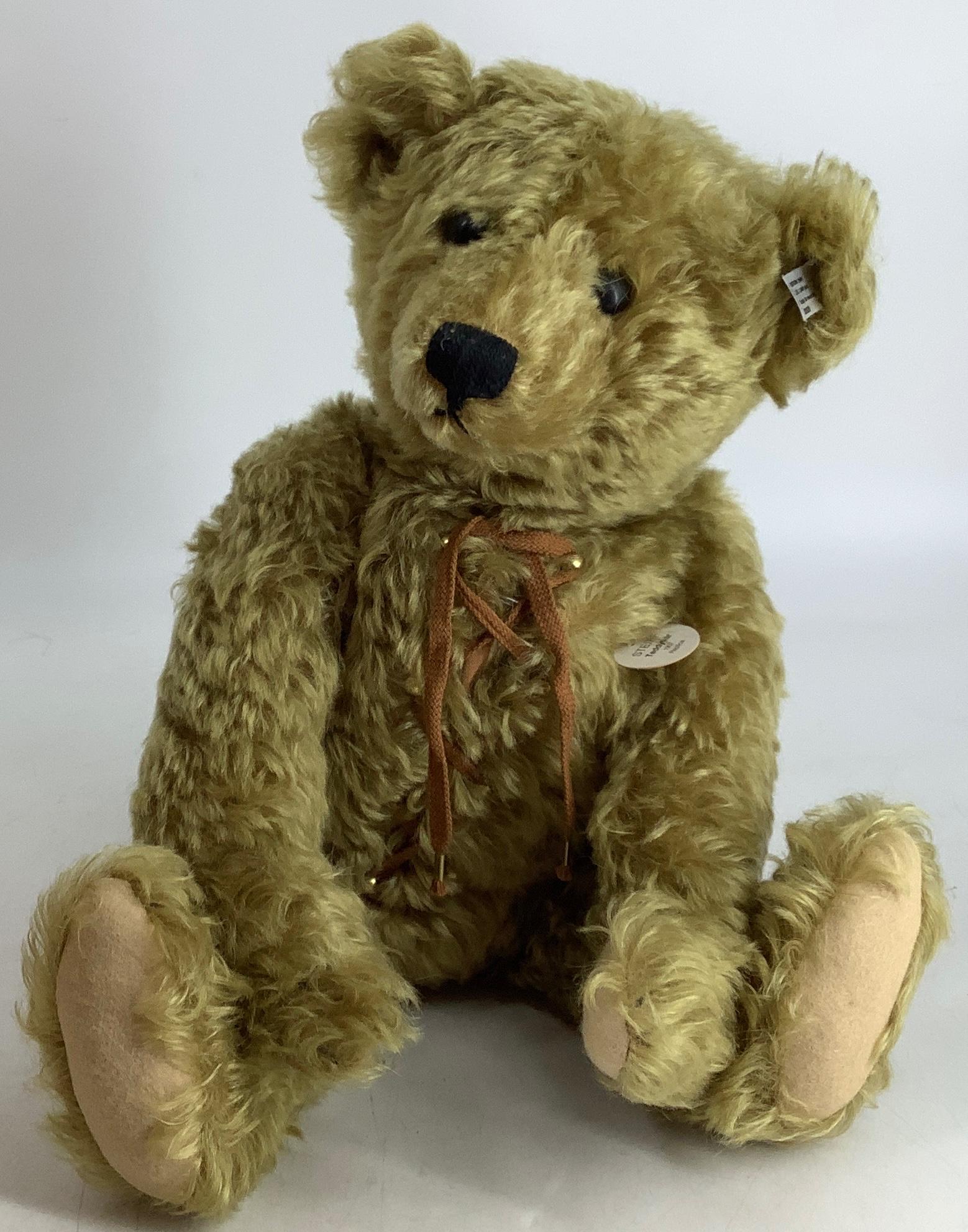 Steiff Replica Teddy Bear with hot-water bottle 1907. 19" curly gold mohair bear with applied ears,: Steiff Replica Teddy Bear with hot-water bottle 1907. 19" curly gold mohair bear with applied ears, glass eyes, stitched nose and mouth, disk jointed head, arms and legs, felt paw pads. His stomach co