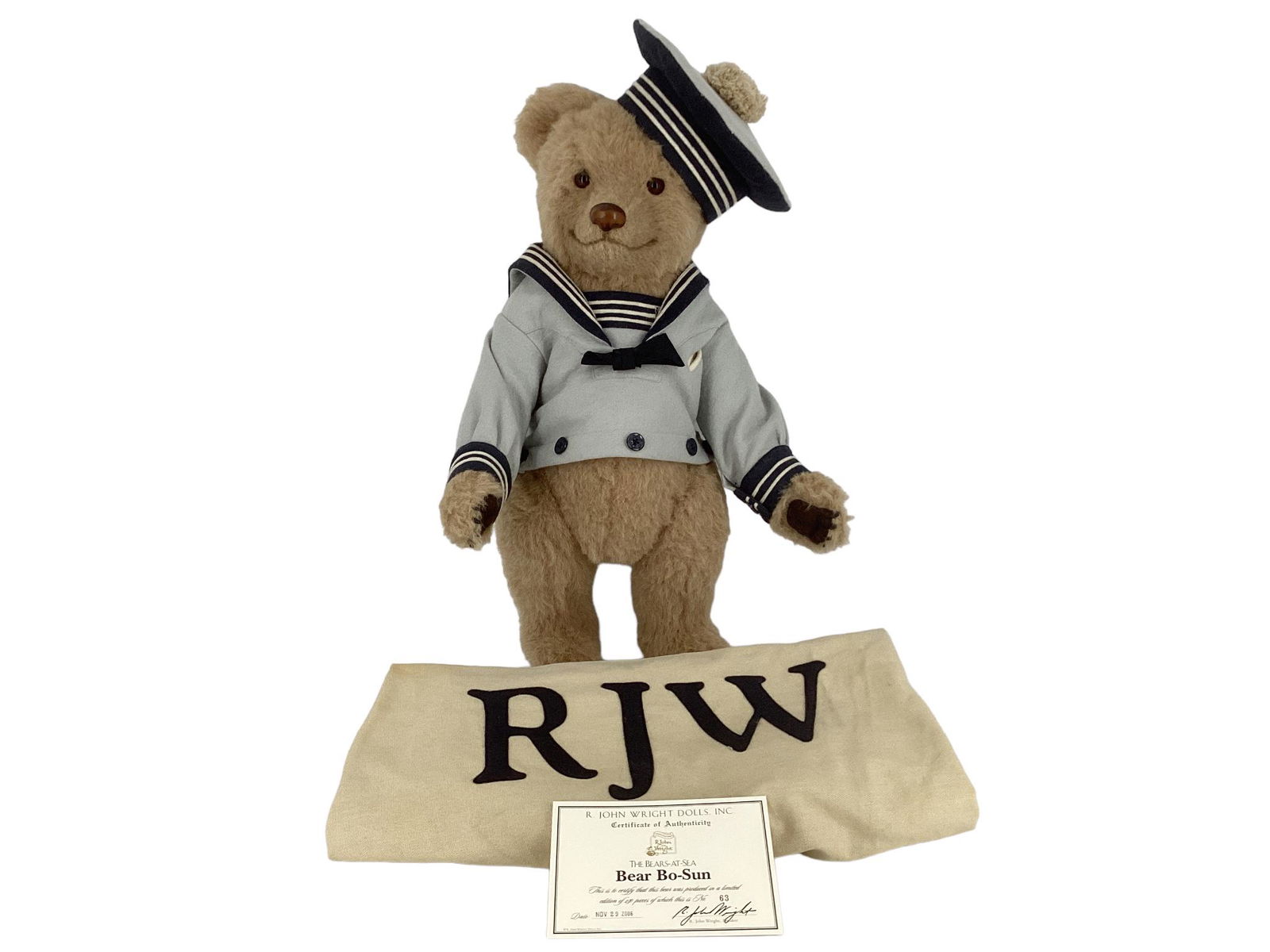 R. John Wright Bear Bo-Sun. Made for the Bears-at-Sea Collection, 21" beige alpaca bear with glass: R. John Wright Bear Bo-Sun. Made for the Bears-at-Sea Collection, 21" beige alpaca bear with glass eyes, leather nose, resin claws, disk jointed head, arms and legs, felt paw pads. Bo-Sun is dressed i