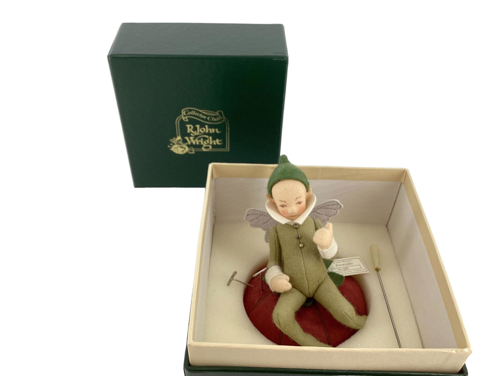 R. John Wright "Periwinkle". 6" wool felt fairy made onto a tomato pin cushion. Jointed at the neck,: R. John Wright "Periwinkle". 6" wool felt fairy made onto a tomato pin cushion. Jointed at the neck, shoulders and hips, molded and painted head, applied wings, Periwinkle was made exclusively for mem