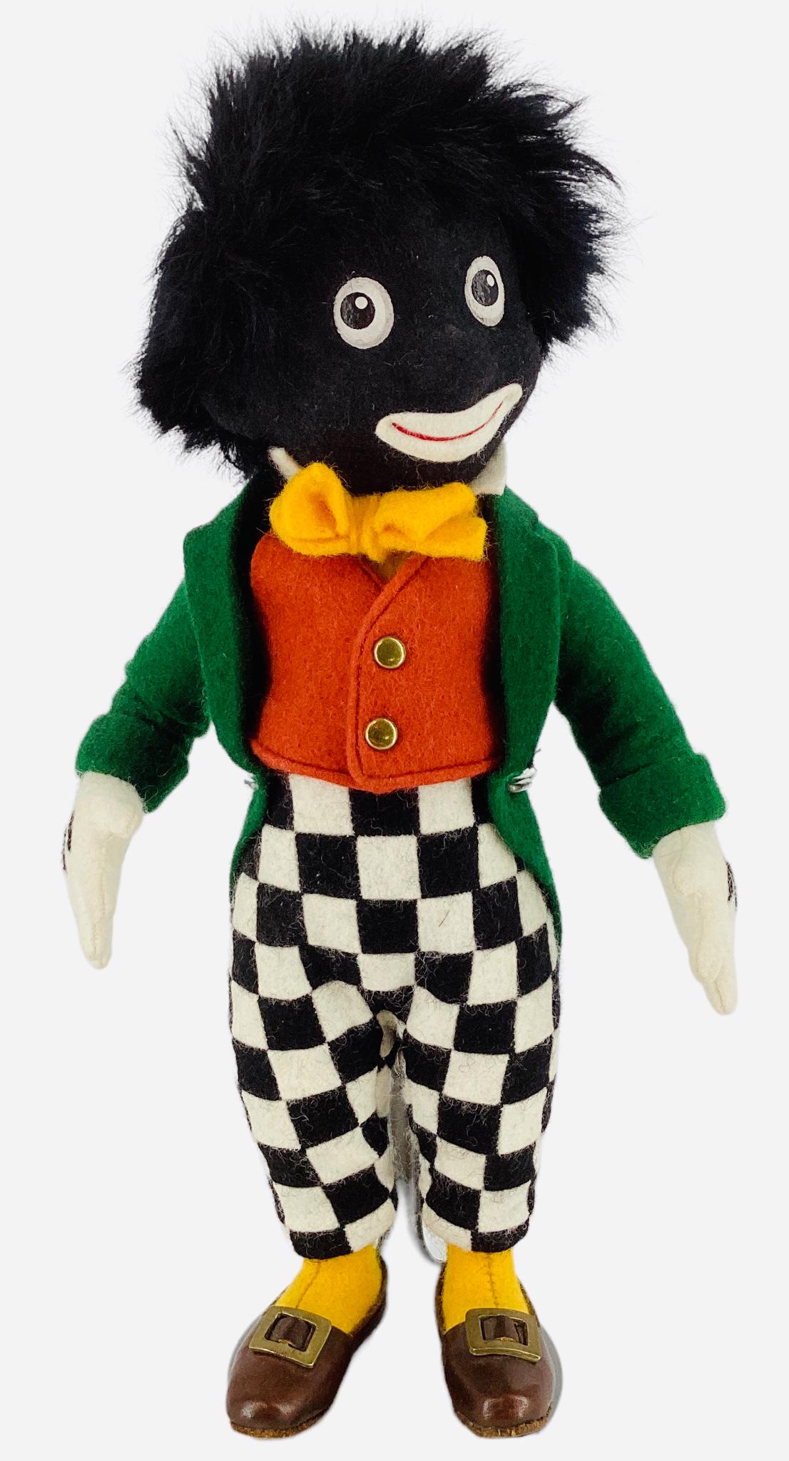 R. John Wright 1997 doll, based on Florence Upton character, 9" wearing green jacket with checkered: R. John Wright 1997 doll, based on Florence Upton character, 9" wearing green jacket with checkered pants, comes with original box and COA. Limited edition No. 0680/2500.