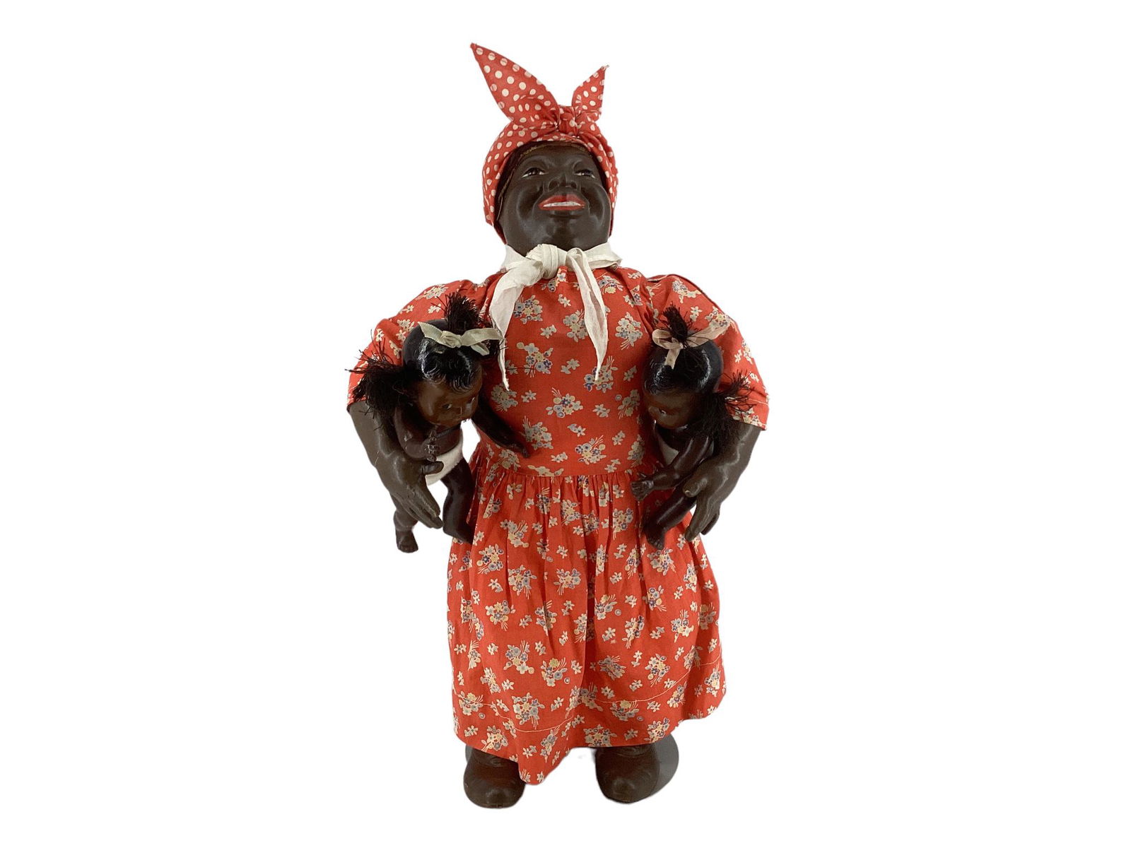 Tony Sarg "Mammy" with babies. 17" composition flange head doll with applied mohair wig, molded and: Tony Sarg "Mammy" with babies. 17" composition flange head doll with applied mohair wig, molded and painted facial features, on unjointed cloth body with composition lower arms and shoes. Comes with t