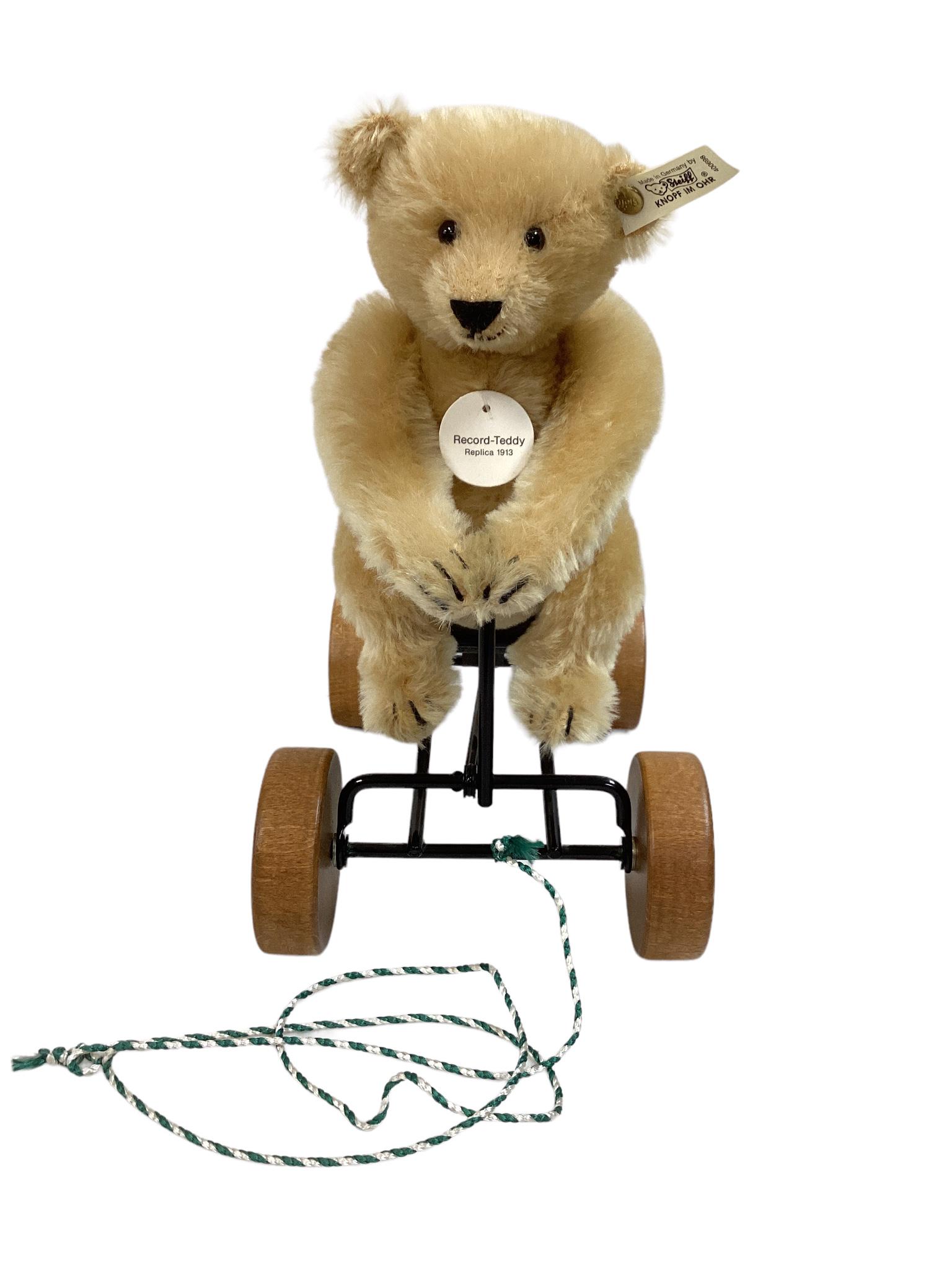 10" x 9" Steiff "Record-Teddy"blonde mohair , jointed on carriage that moves automatically when: 10" x 9" Steiff "Record-Teddy"blonde mohair , jointed on carriage that moves automatically when pulled & automatic voice, pull cord (voice does not work) 2650/4000 and retains his ear tag.