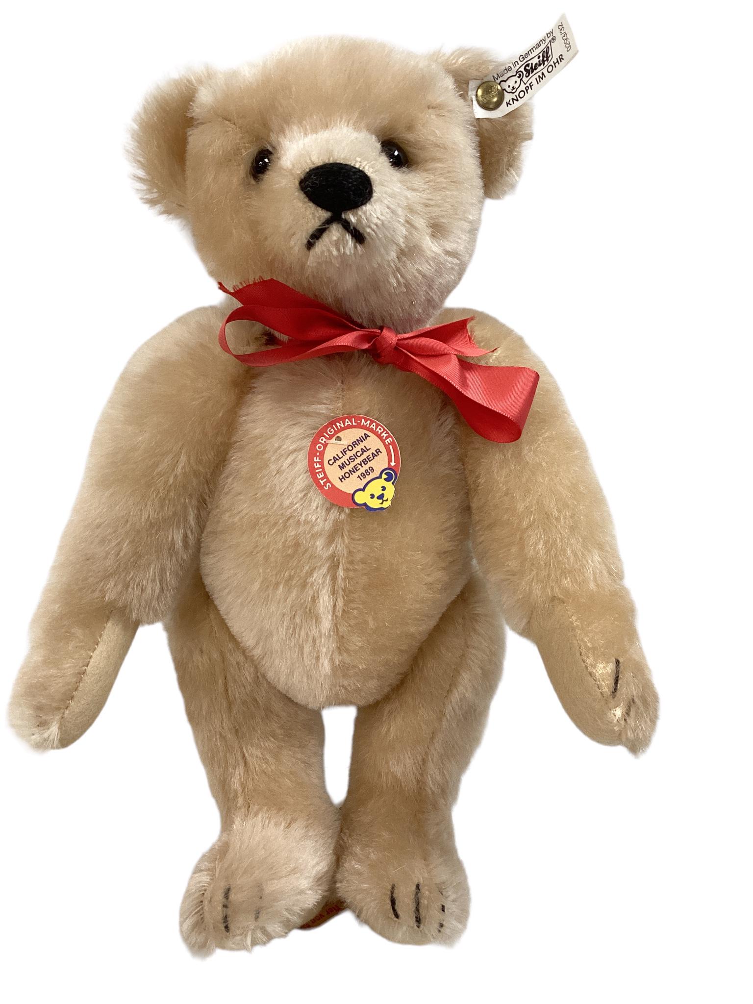12" Steiff music box "California Musical Honeybear 1989" #17/1000, tagged. Plays ‘Teddy: 12" Steiff music box "California Musical Honeybear 1989" #17/1000, tagged. Plays ‘Teddy BearsPicnic’.