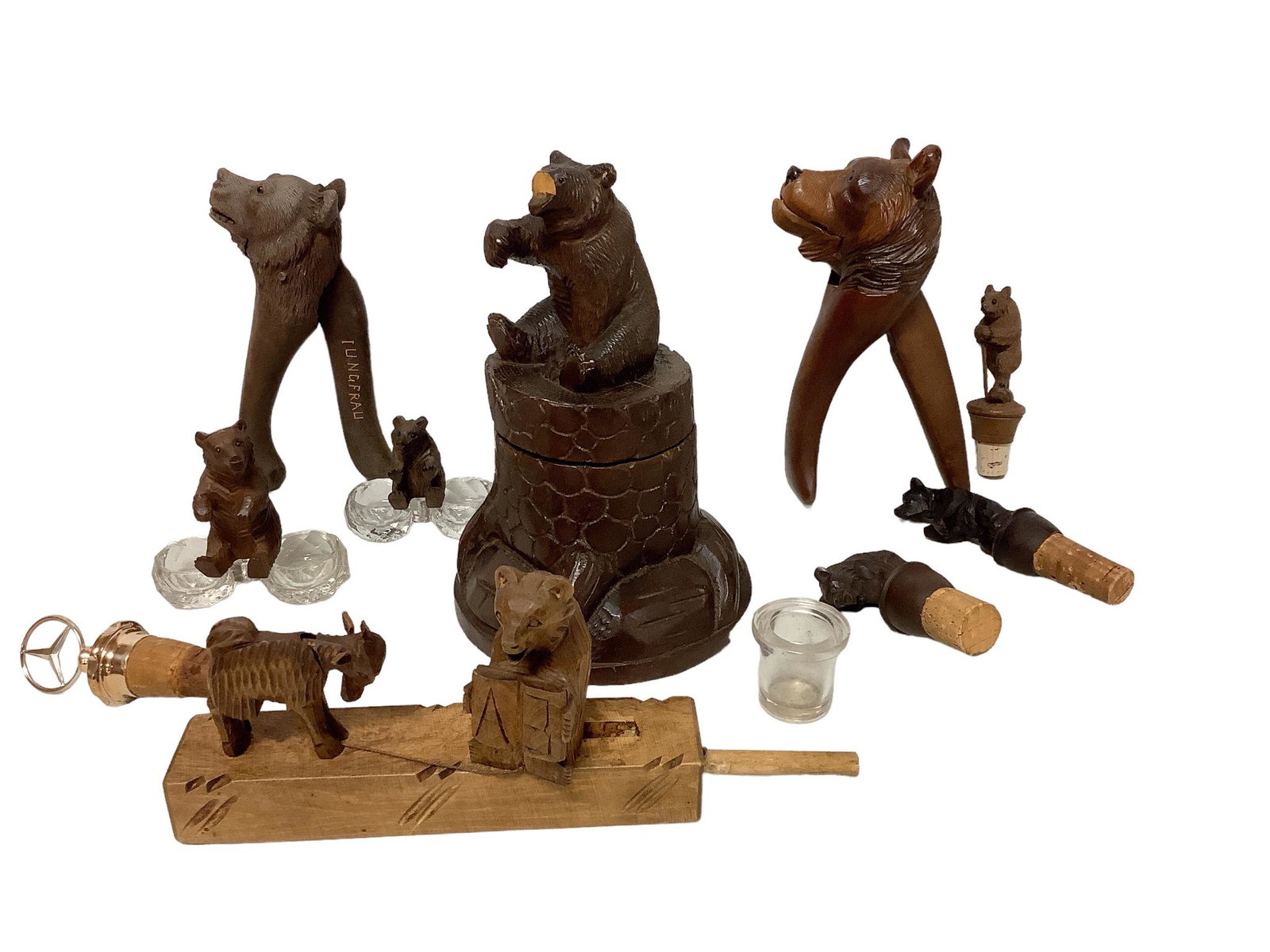 Lot of Black Forest carved bear-motif wood items including several corked bottles stoppers, salts, (1 of 2)