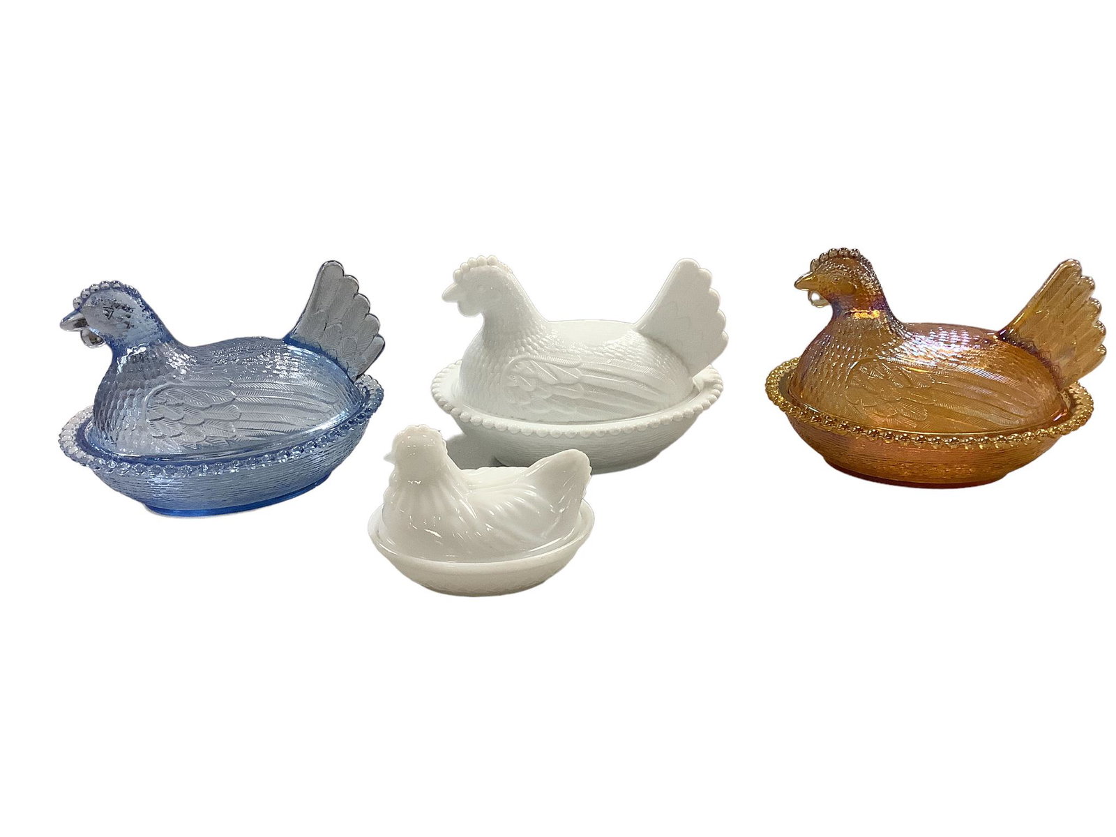 Lot of three 5.25”h nesting hens and a 3.5”h milk glass nesting hen.: Lot of three 5.25”h nesting hens and a 3.5”h milk glass nesting hen.