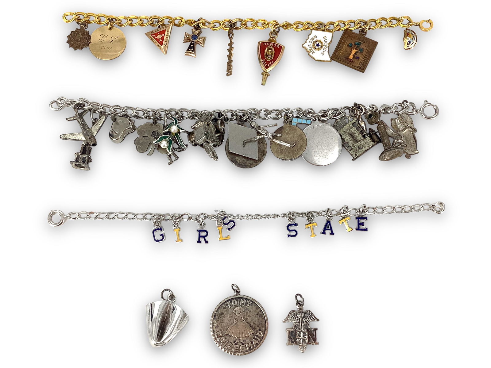 Vintage Charm Bracelets: Vintage Charm Bracelets Three bracelets, with charms including a skeleton with moving arms and legs, airplane, devil, piano, four leaf clover and more, including some sterling.