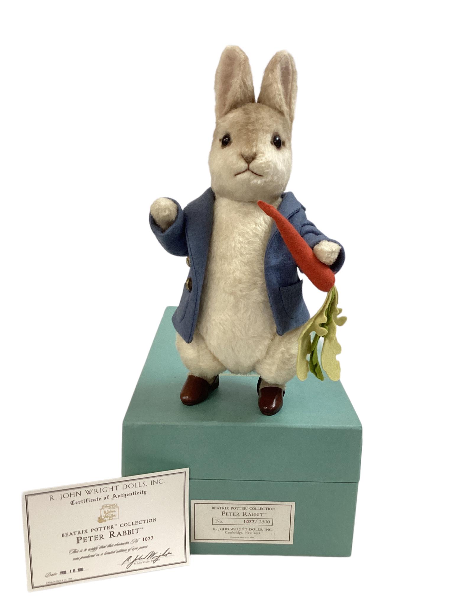 12" R. JOHN WRIGHT "PETER RABBIT" FROM THE BEATRIX POTTER COLLECTION. WOVEN MOHAIR WITH EMBROIDERED: 12" R. JOHN WRIGHT "PETER RABBIT" FROM THE BEATRIX POTTER COLLECTION. WOVEN MOHAIR WITH EMBROIDERED FEATURES AND GLASS EYES. FULLY JOINTED AND DRESSED IN A BLUE JACKET WITH BRASS BUTTONS AND LEATHER S