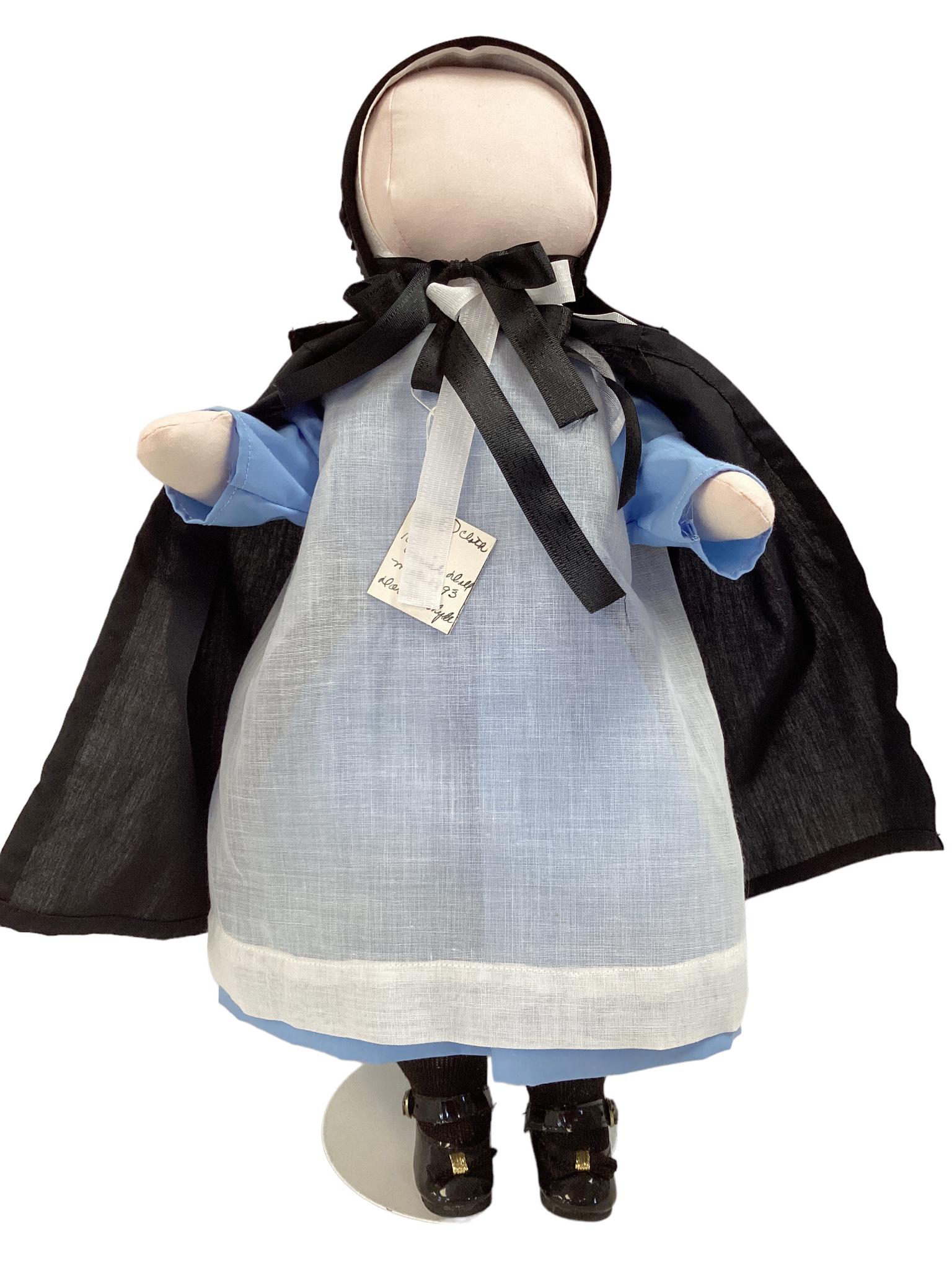 16" cloth filled Amish doll made in 1993 by Doris R. Whyde. She is wearing a blue and white dress (1 of 3)