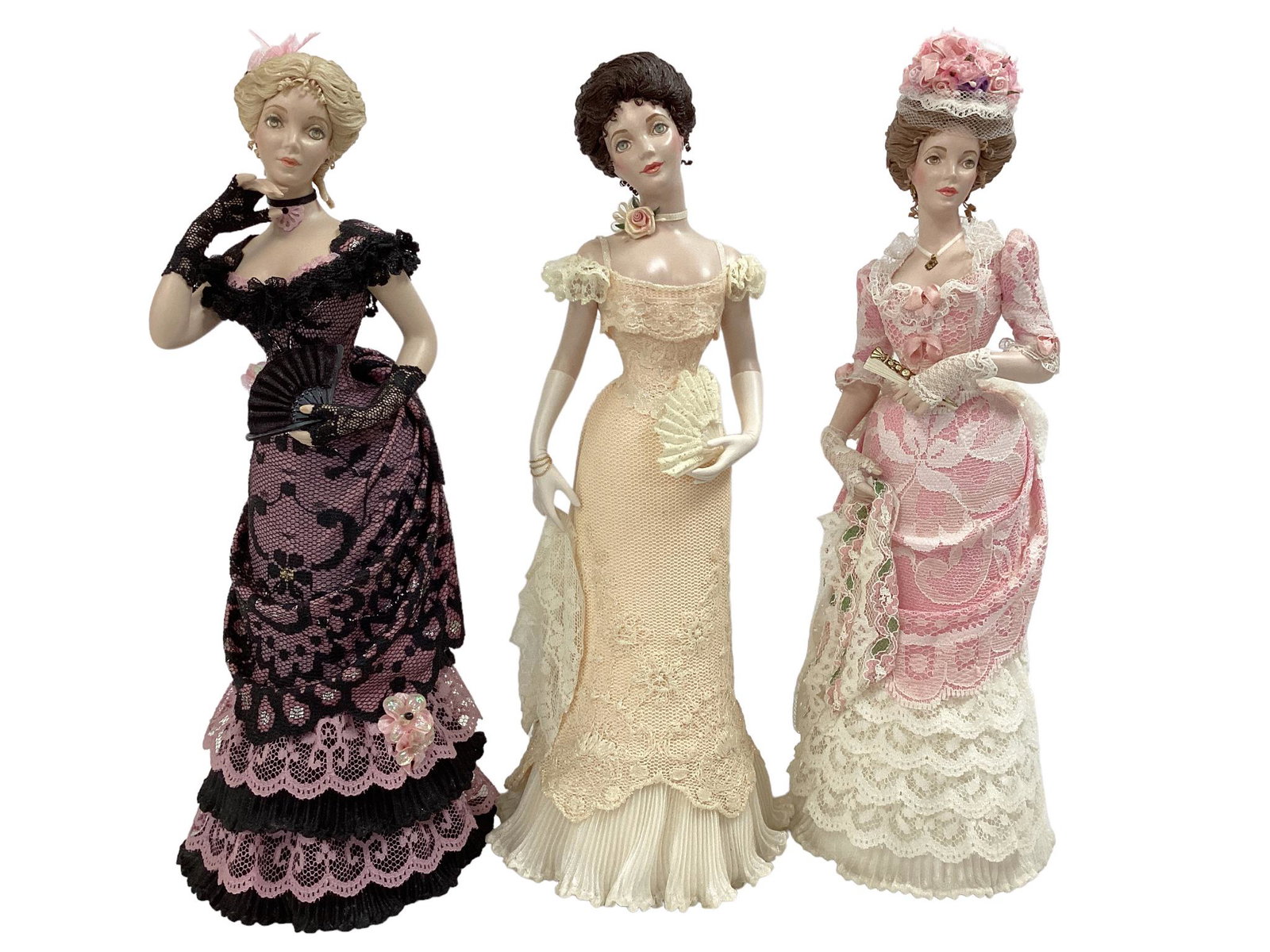 (3) fashion doll figures by artist Jamalea Corrre. Includes 10 1/2" "Ivy" in pale peach gown, 11": (3) fashion doll figures by artist Jamalea Corrre. Includes 10 1/2" "Ivy" in pale peach gown, 11" "Linda" in pink and white lace, and 10 1/2" "Natasha" in pink and black lace. All three dolls have bis
