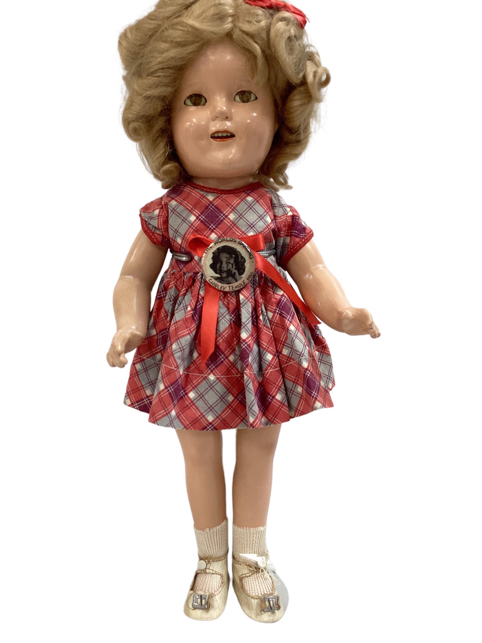 15" Ideal "Shirley Temple" composition doll, mohair wig, sleep eyes, applied eyelashes, painted: 15" Ideal "Shirley Temple" composition doll, mohair wig, sleep eyes, applied eyelashes, painted eyelashes and facial features, open mouth with teeth. She is wearing a purple, gray and red dress, one p
