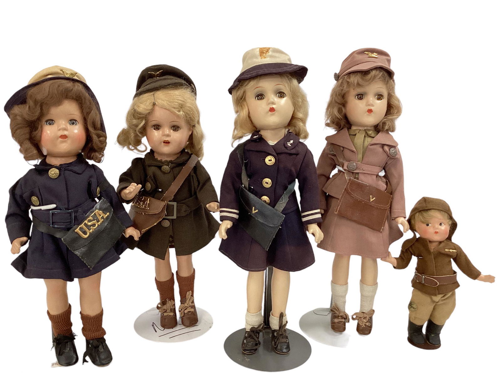 (4) Mid-century dolls in Military uniforms, including Madame Alexander and Effanbee.: (4) Mid-century dolls in Military uniforms, including Madame Alexander and Effanbee. (2) 14" and (2) 12" dolls, all seem to be in original vintage uniforms with accessories. Included is vogue composit