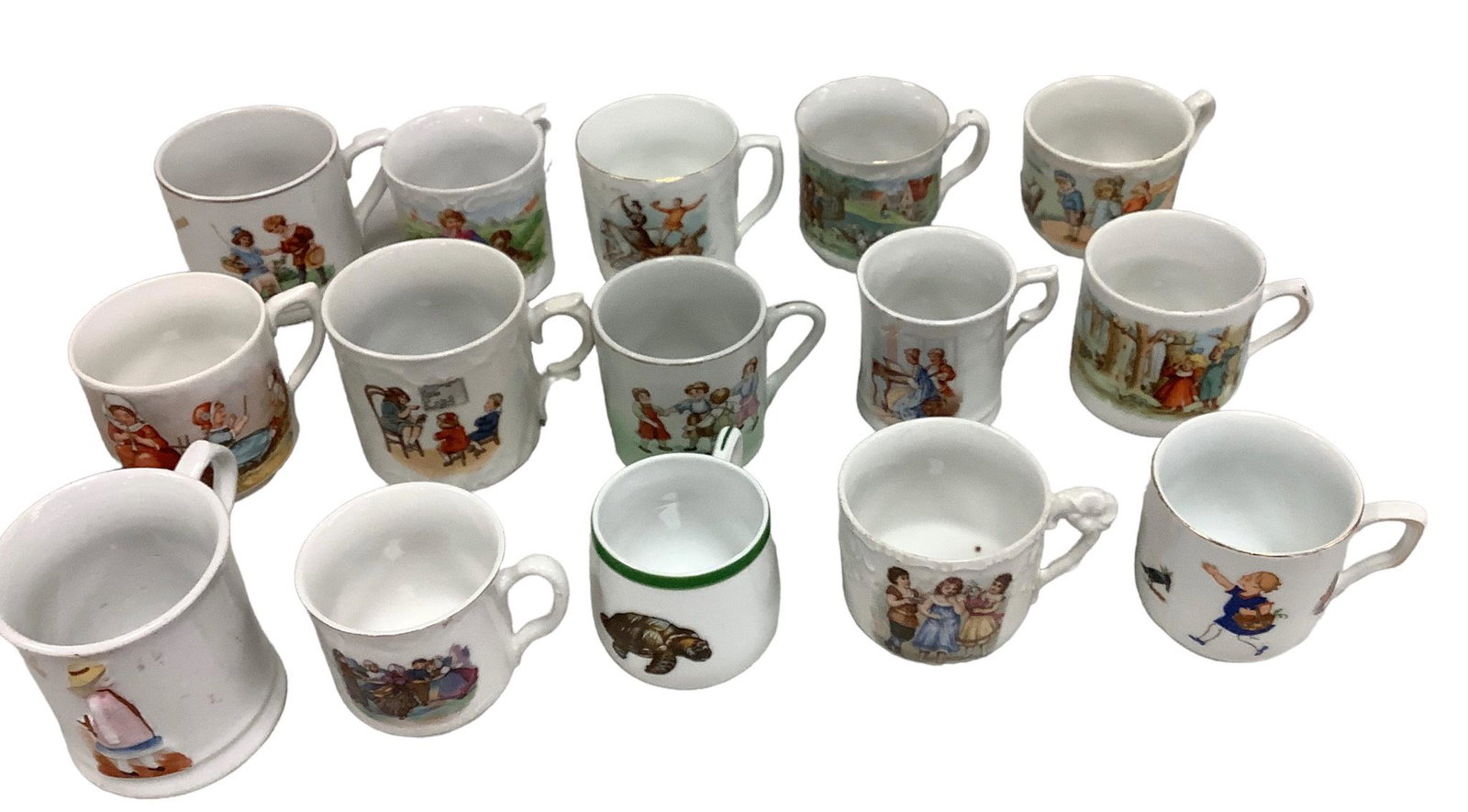 Set of 15 Childrenís China Tea Cups and Mugs: A variety of childrenís themed tea cups and mugs, ranging from 2.25î to 3î high. All in good condition with no obvious chips or cracks. Five of the cups have maker's marks as shown in p
