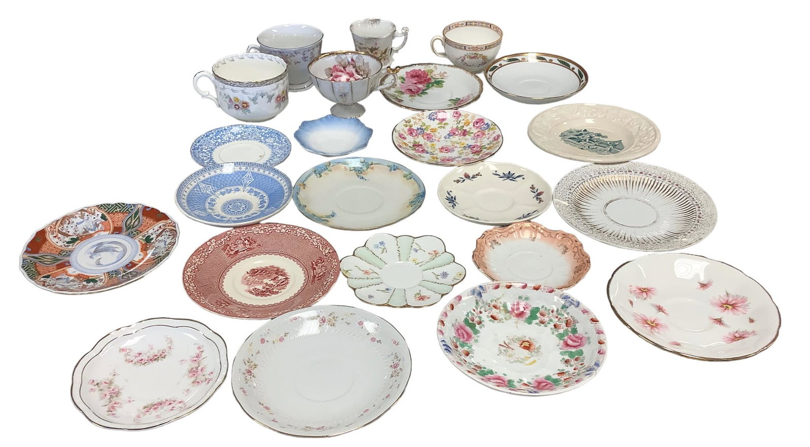 Lot of (23) Pieces Unmatched Cups and Saucers: Includes (5) cups and (18) saucers by makers including D&C from France, English Staffordshire, English Royal Stafford, Mintons in England and Japanese Cherry China, among others.Shipping Note: $65.00 