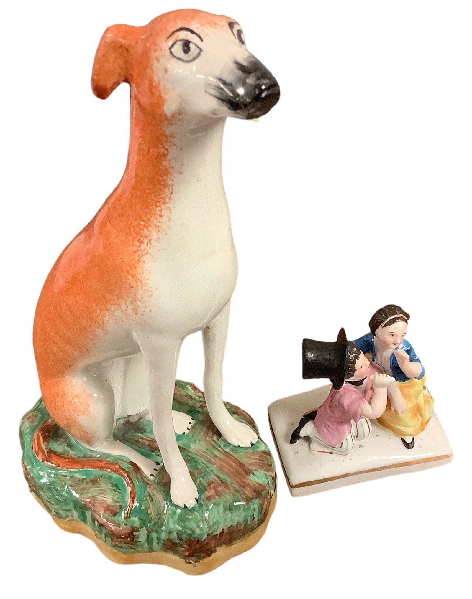 Proud English Staffordshire Porcelain Dog and Victorian Lady and Gent China Piece: Tall porcelain dog in sitting position with markings on bottom as shown. Greyhound or Whippet is 8î tall, made in England. Smaller figurine is of a Gent in top hat and lady whispering to him, no 