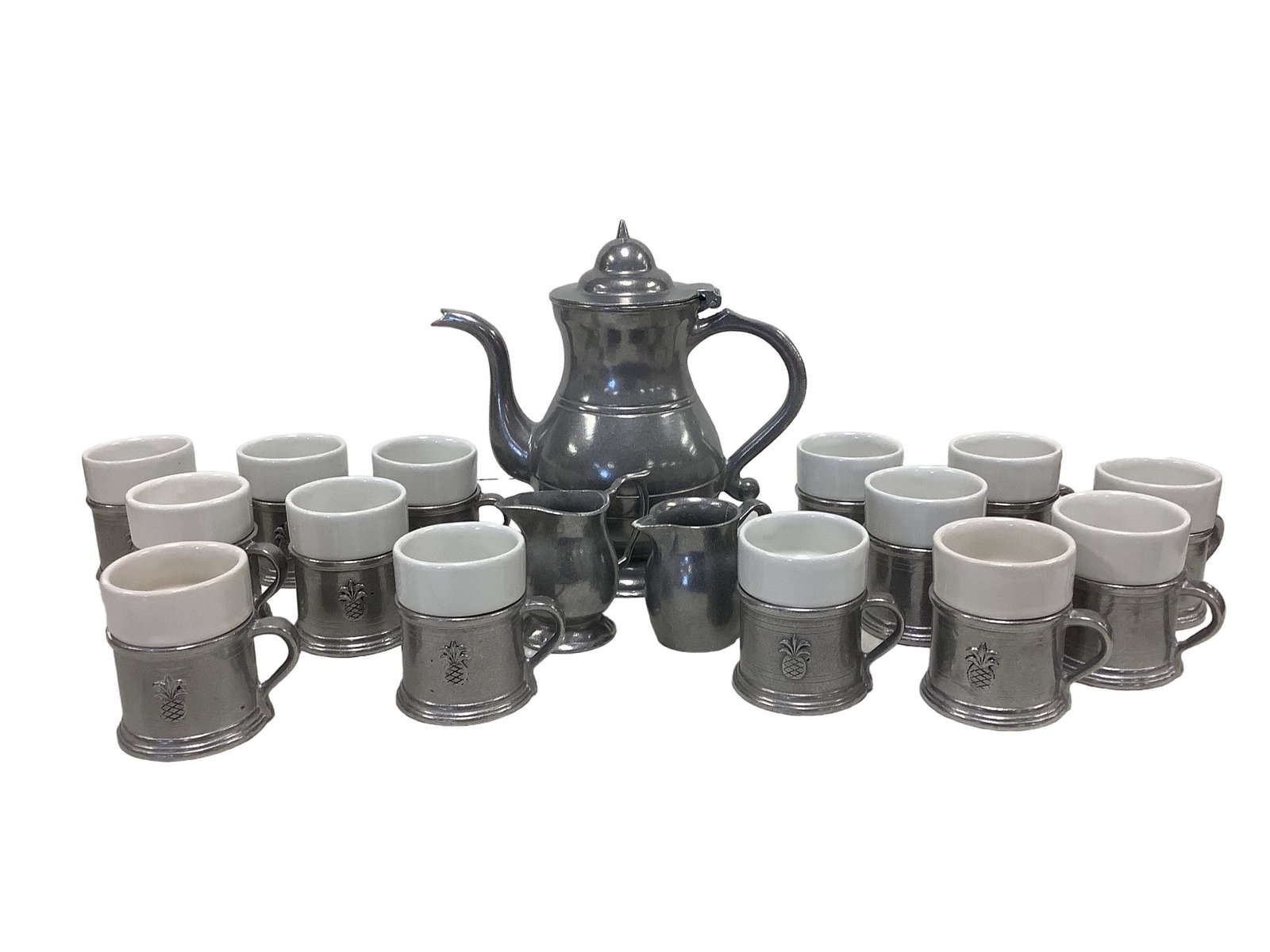 Pewter Coffee Pot and Mugs: Pewter Coffee Pot and Mugs One unmarked pewter coffee pot measuring 4.25î in diameter at opening 10.5î tall and 10.5î from the tip of the spout to the outermost handle. One unmarked pew