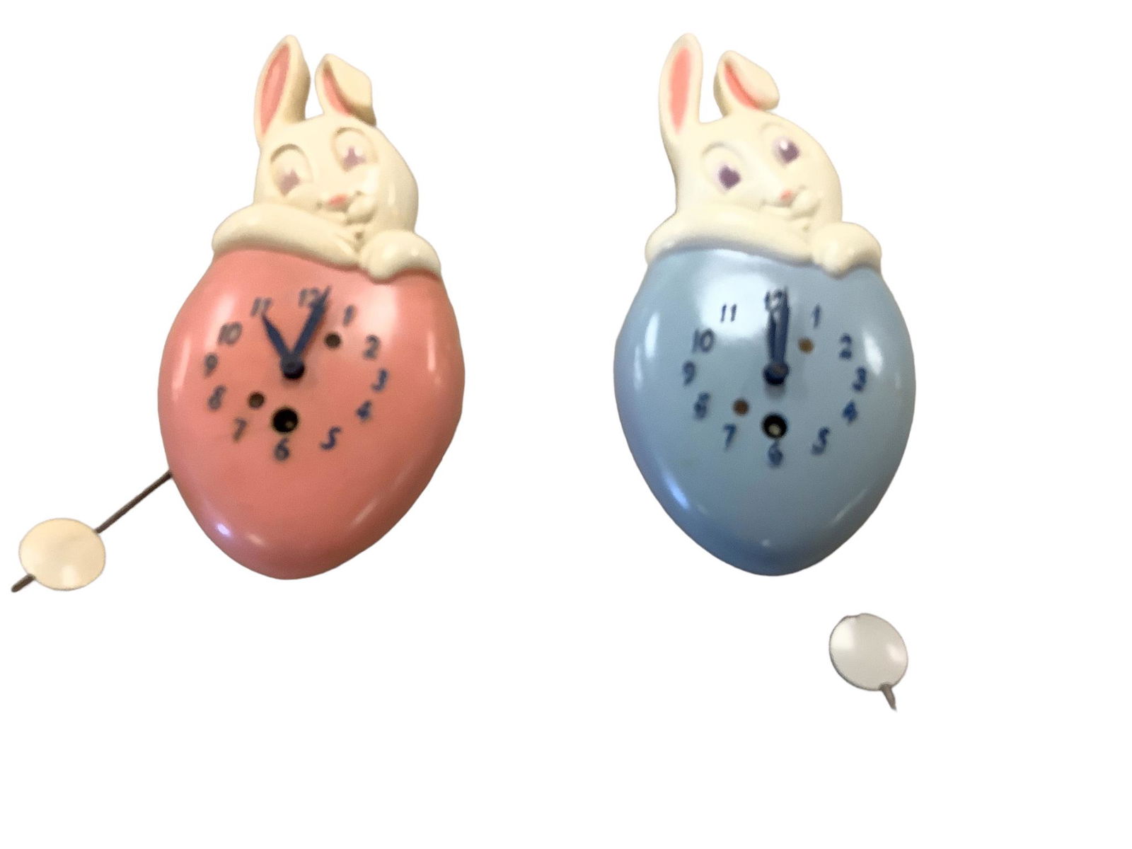 (2) Lux Honey Bunny Wall Clocks: (2) Lux Honey Bunny Wall Clocks (1) pink and white, and the other blue and white. Has not been tested for working conditions. No Key.