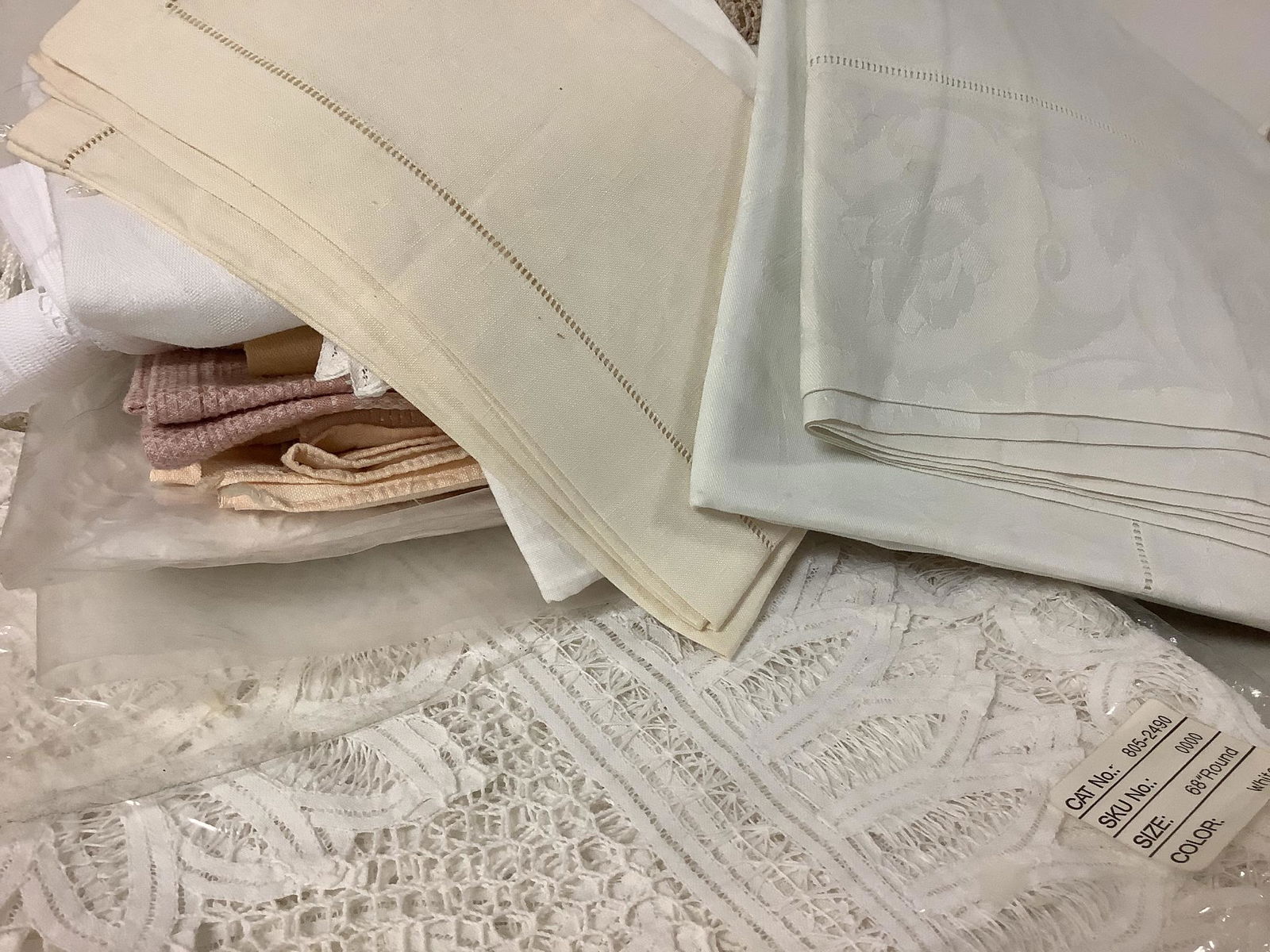 Multiple Lovely Linens: Multiple Lovely Linens Includes a white 68î round lacey table cover, linen napkins, pillowcases, table runners, hand towels, tablecloths and doilies in good condition.