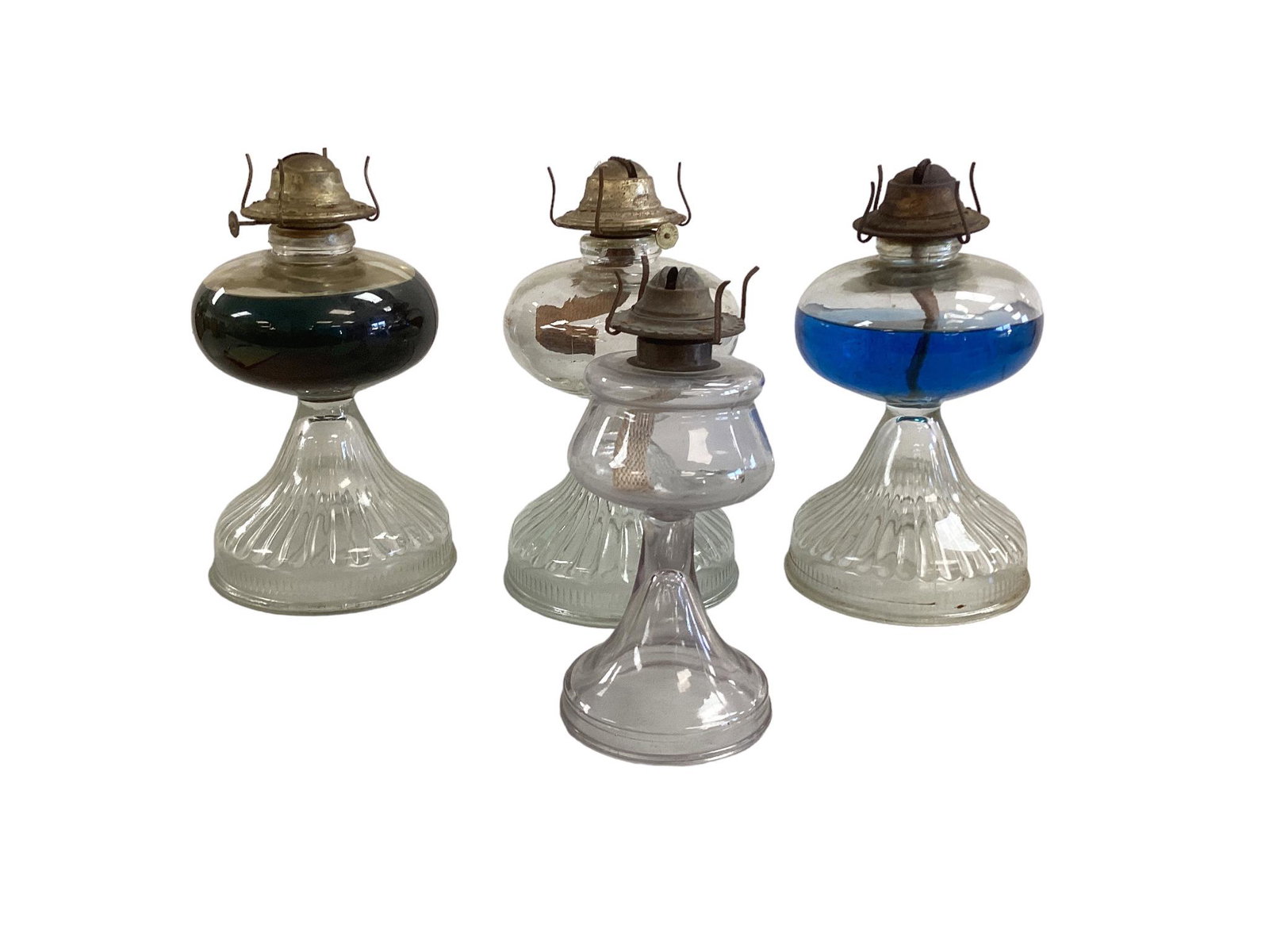 Four oil lamps: Four oil lamps One smaller lamp measures 7.25îH and 12î in circumference around the largest part. Three larger lamps measure 9îH and 18.25î in circumference at the largest part.