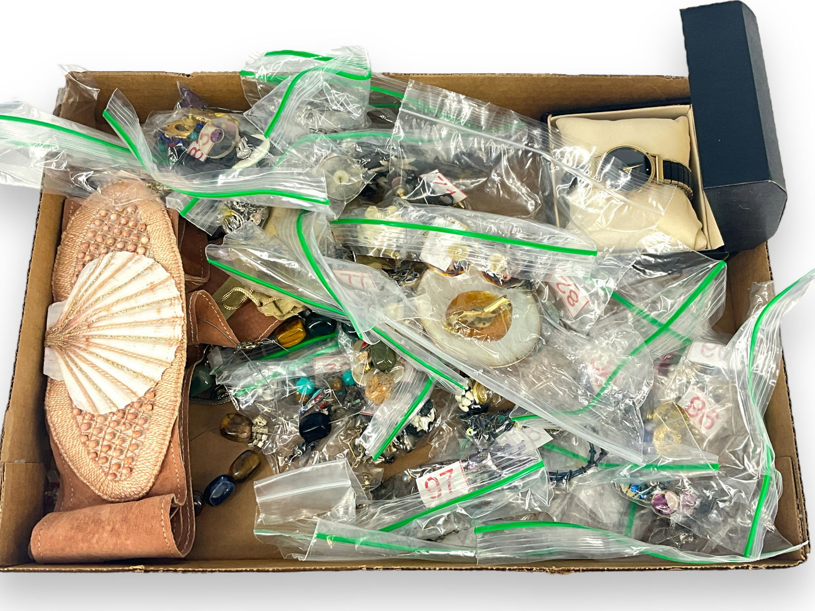 Box Lot Of Jewelry & Accessories: Box Lot Of Jewelry & Accessories Dozens of pairs of earrings, including post back, clip on and dangle styles, new old stock wrist watch from Swiss Charter, 1980’s style belt with a shell in the