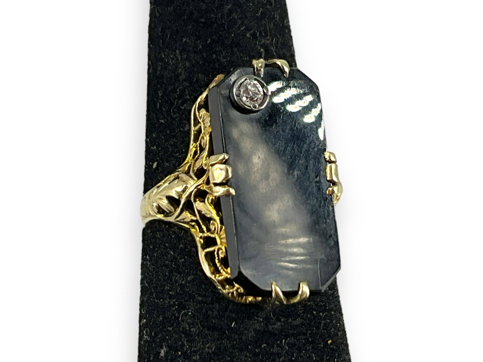 Antique Gold and Onyx Ring with Diamond Accent: Antique Gold and Onyx Ring with Diamond Accent 14kt yellow gold, 2.7 grams total weight, size 5, openwork mounting, stamped and tested, with 19.5mm x 9.5mm polished black onyx center stone in fancy-pr