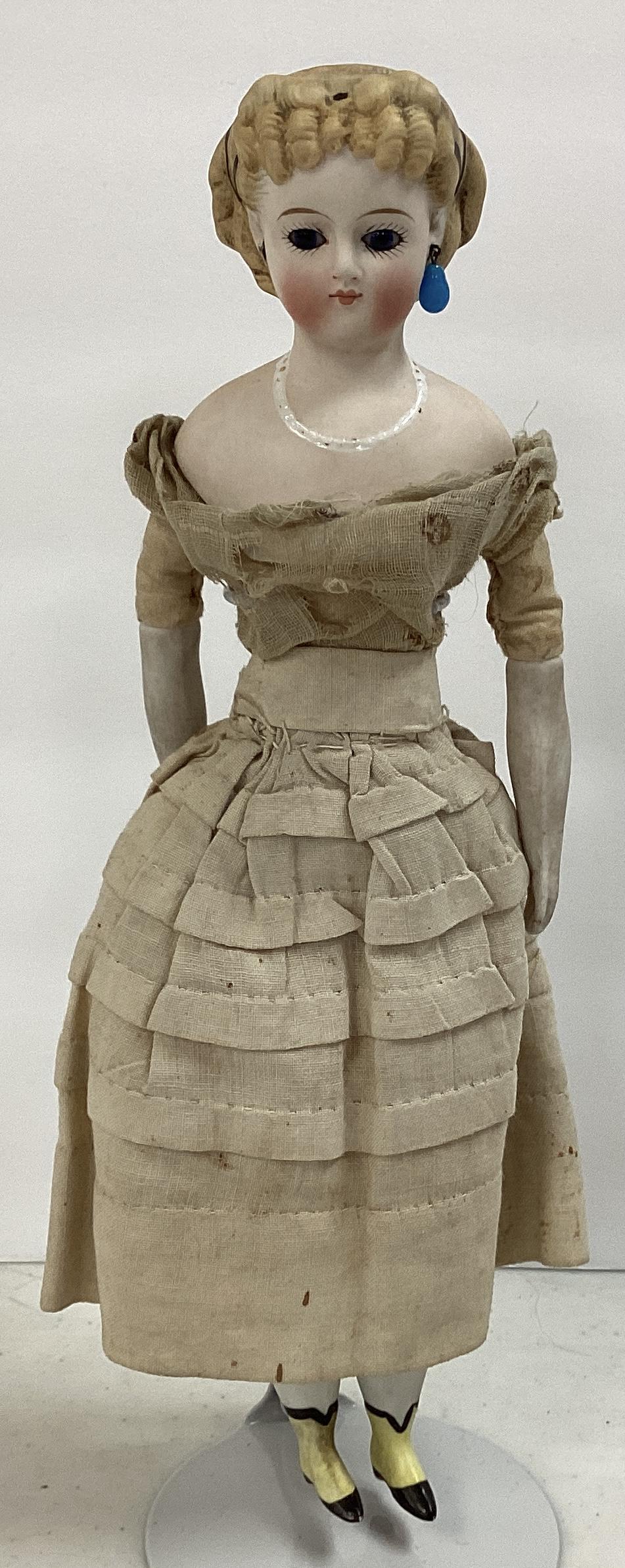 Early Tinted Bisque Shoulder Head Lady with Fancy Hairstyle: Early Tinted Bisque Shoulder Head Lady with Fancy Hairstyle 9 1/2" doll with molded and painted elaborate hairstyle, inset glass eyes, exposed pierced ears, closed mouth, molded luster necklace, on st