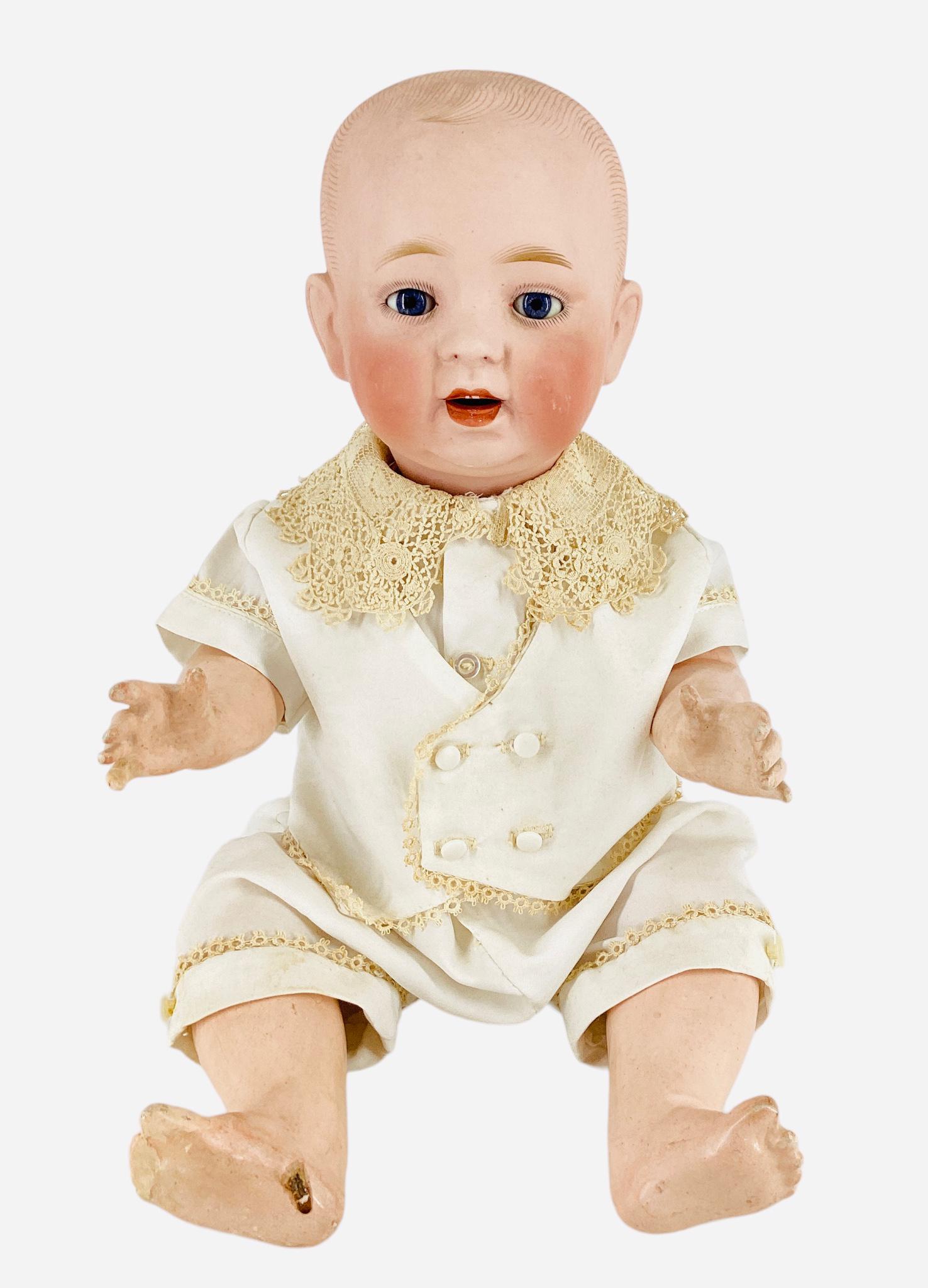 German Bisque Socket Head Character Baby: German Bisque Socket Head Character Baby 18" solid dome doll with molded and painted hair, glass sleep eyes, open mouth with two upper painted teeth, on chunky five-piece composition bent limb baby bo