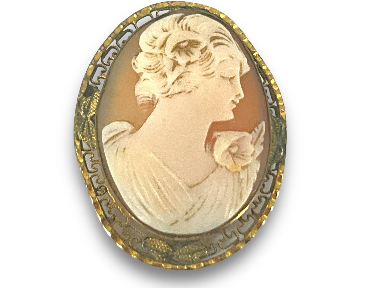 Antique Cameo Pin: Antique Cameo Pin Openwork mounting, high relief cameo in carnelian shell, 36.25mm in size, accented by floral decorations, right facing portrait with level head. No cracks/chips at time of listing.