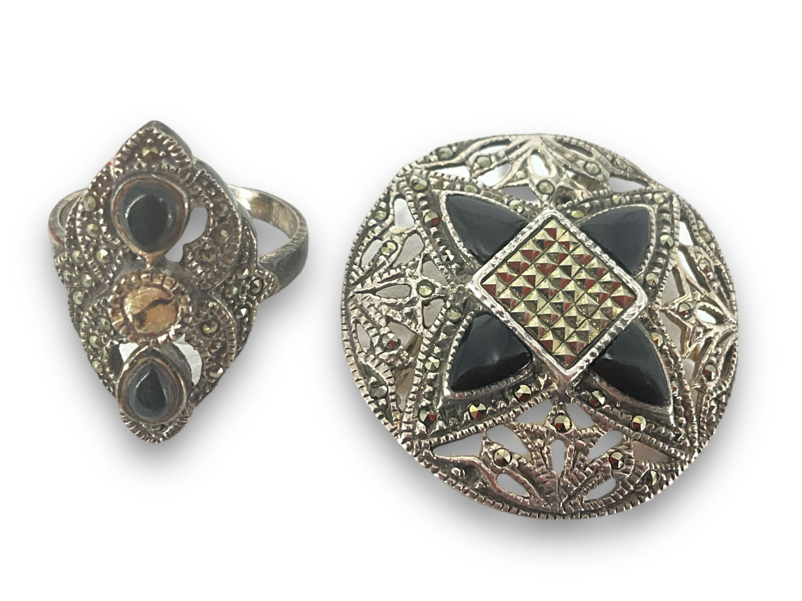 Sterling Silver Pin and Ring: Sterling Silver Pin and Ring 33.5mm pin and size 7.5 ring, 0.44 troy ounces total weight, ring and pin feature onyx stone cabochons inlaid in mounting with marcasite/pyrite adornments. Stamped and tes