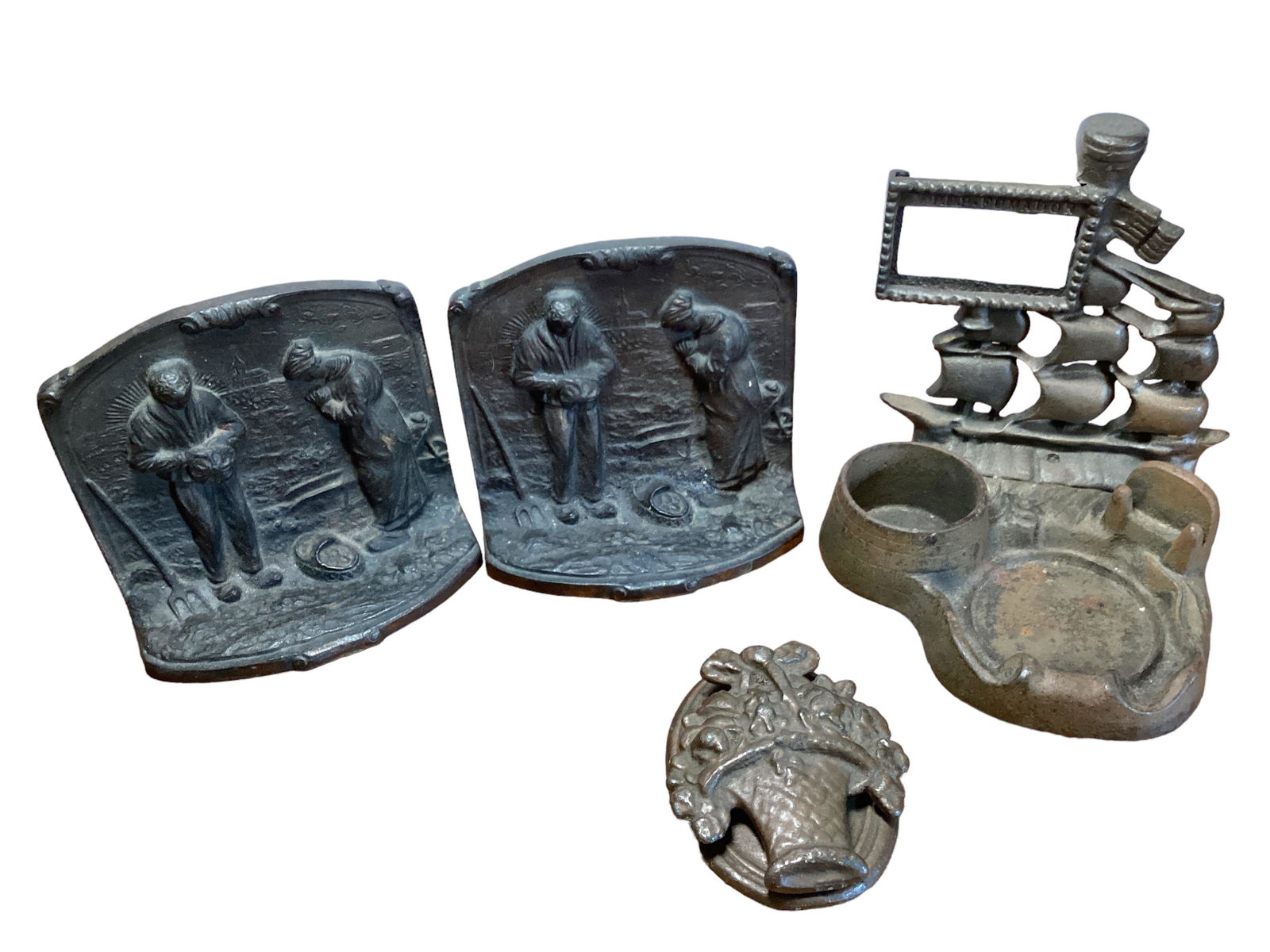 Cast Bookends, Door Knocker & Sailing Ship Ashtray: Cast Bookends, Door Knocker & Sailing Ship Ashtray The cast bronze bookends are marked BRONMET. They are 4 1/2î H x4 3/4î W. The sailing ship is a picture frame in the sails, a cigarette hol