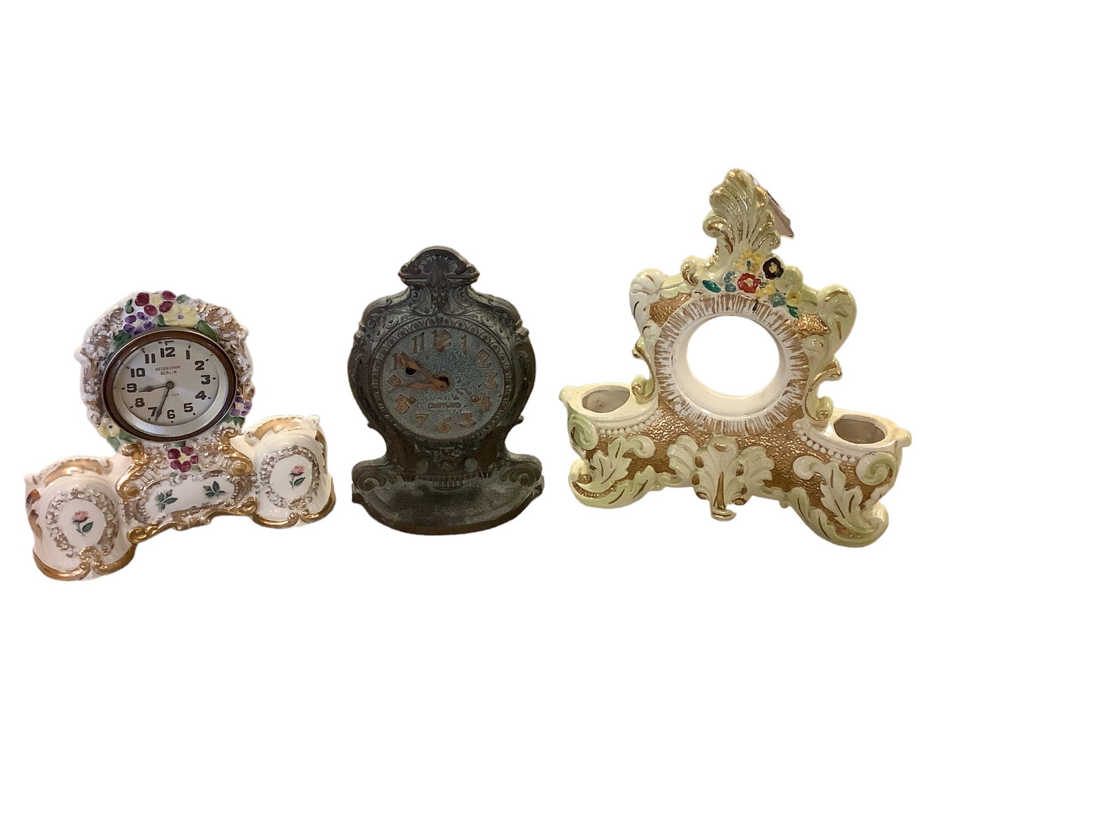 Lot of (2) Clocks and (1) Clock Case: Lot of (2) Clocks and (1) Clock Case One clock is porcelain and marked Heidschun Berlin, one is ìCraftwoodî and is marked Miller Clocks, the last is a porcelain clock case. Ranging in height