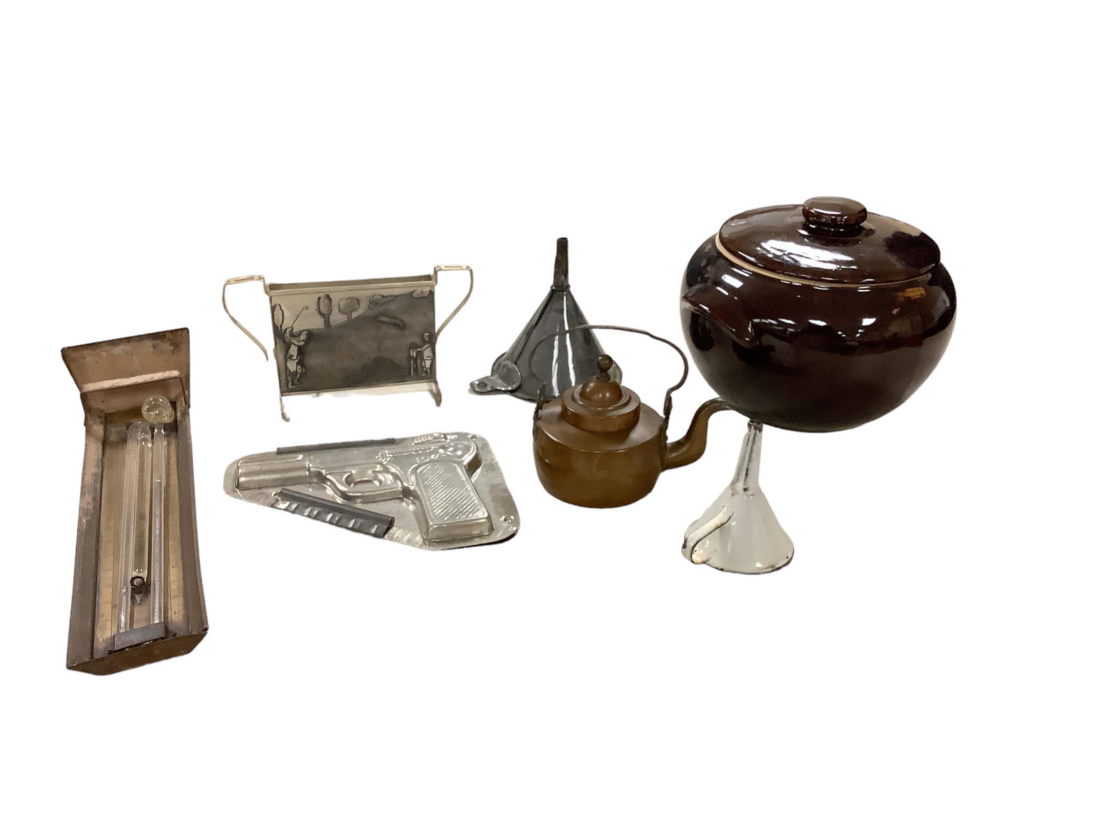 Miscellaneous Grouping of Metal Items: Miscellaneous Grouping of Metal Items Revolver shaped metal candy mold, 2 metal funnels, vintage metal thermometer/barometer, small 4.75î tall teapot, golf motif narrow divided silver plate piece