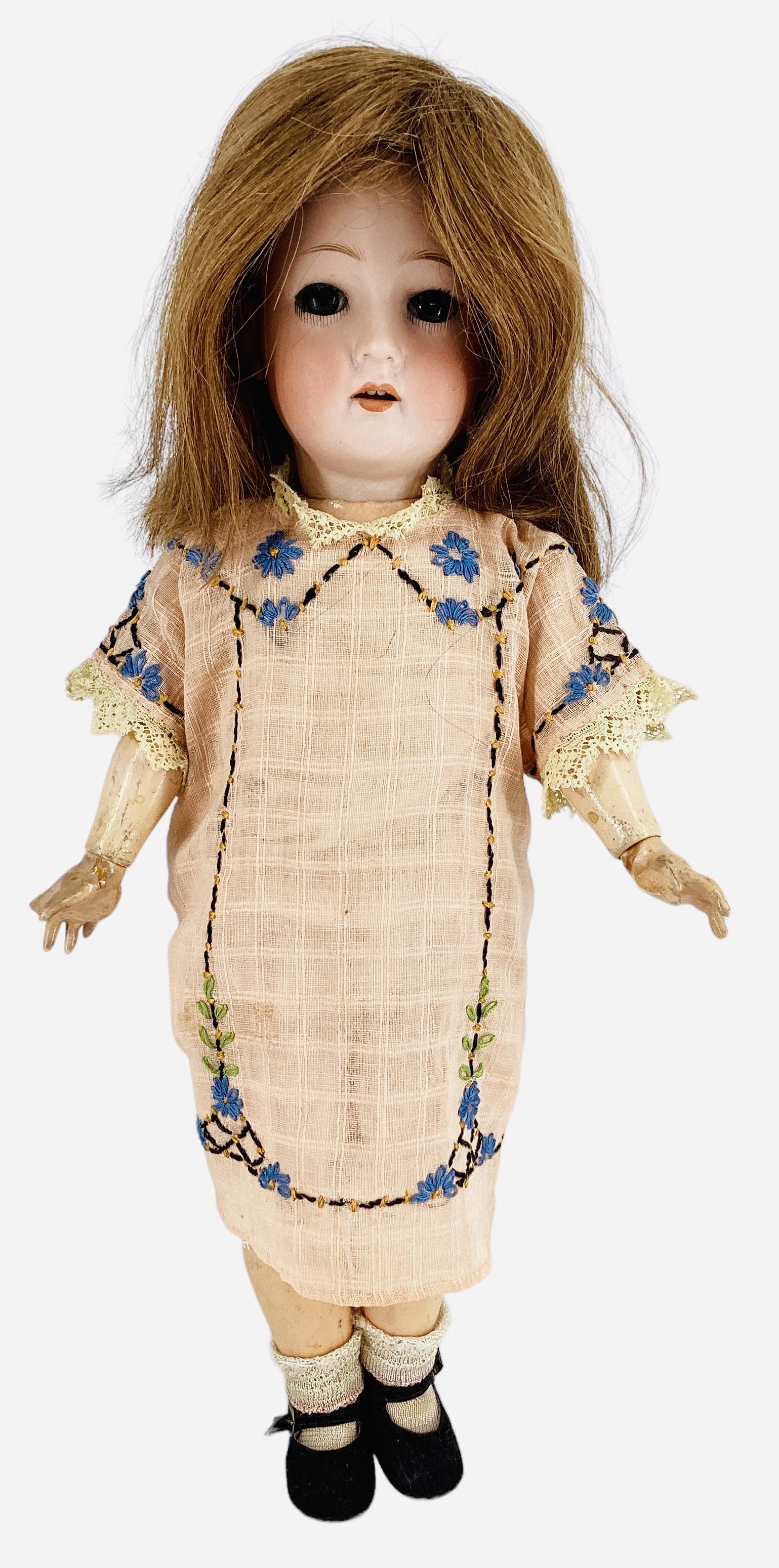 German Bisque Socket Head Girl: German Bisque Socket Head Girl 18" doll with human hair wig, glass eyes have been set, open mouth with teeth, on jointed composition body. Hairline left side of forehead from rim, right index finger m