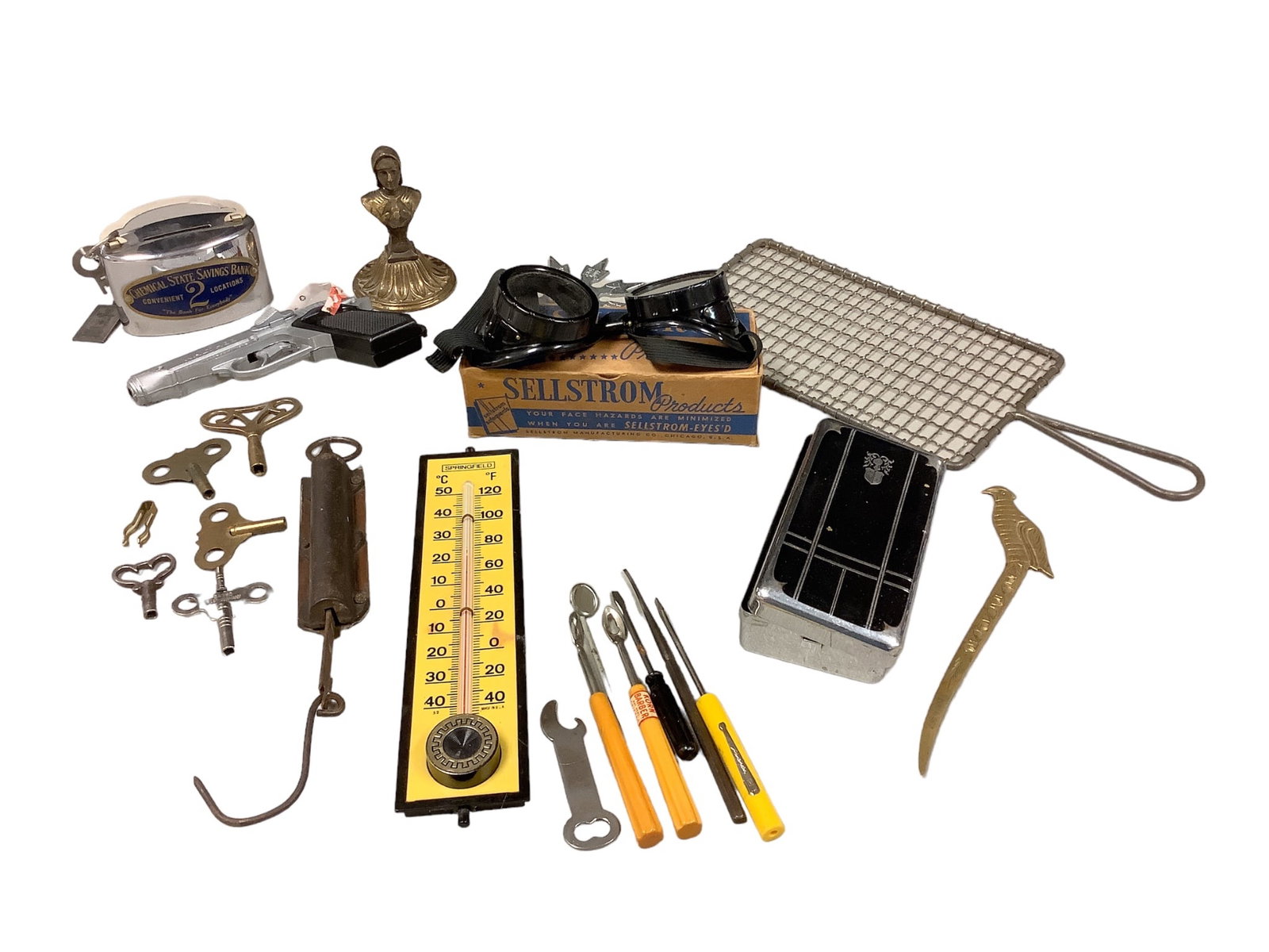 Eclectic lot of Metal/Brass Items: Eclectic lot of Metal/Brass Items Five winding keys, a Walther cap gun, Sellstrom safety goggles, throwing star, a 5îx2.5î metal box with lid, Chemocal State Savings Bank personal bank with 