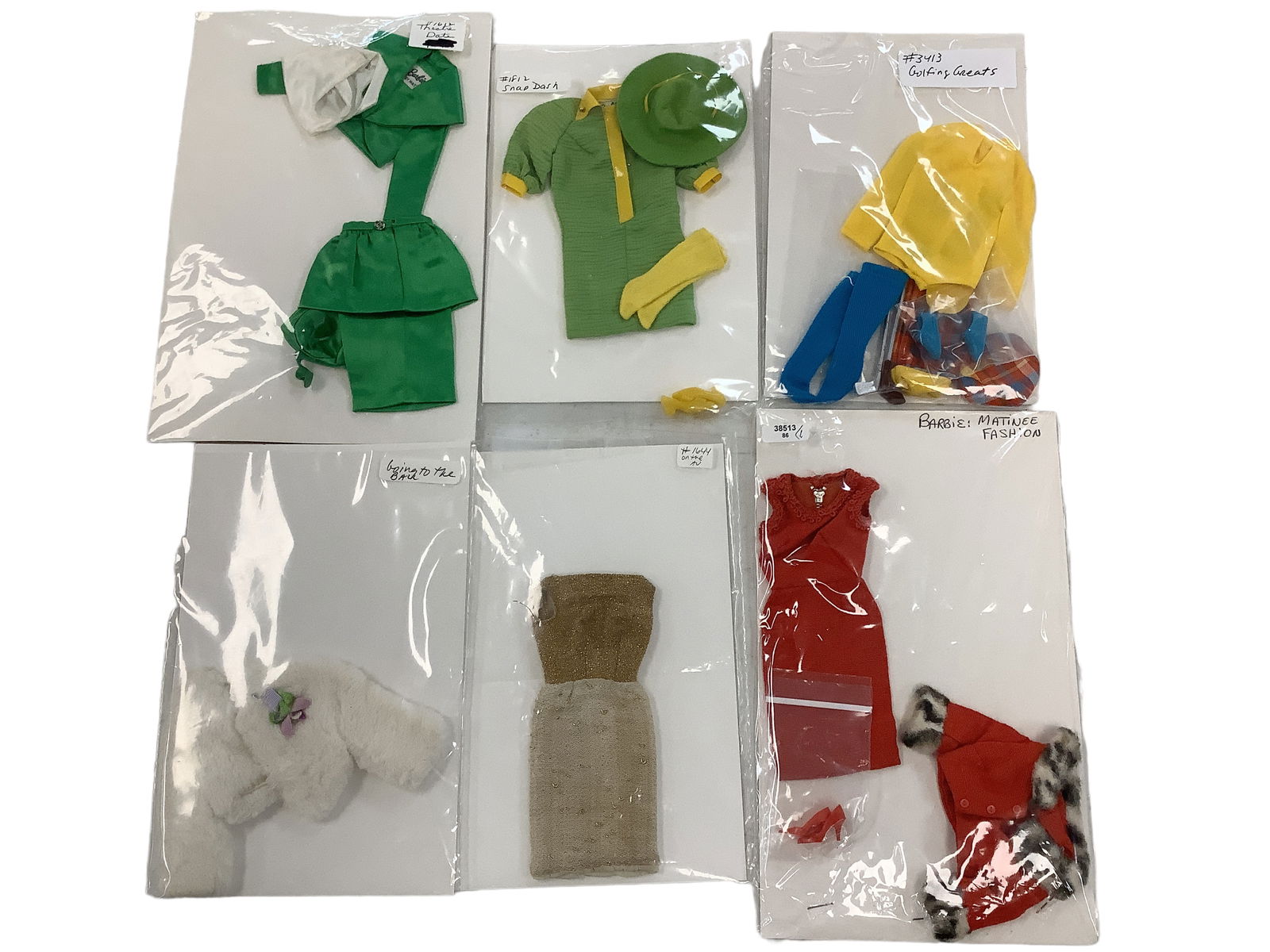 (6) VINTAGE BARBIE OUTFITS: (6) VINTAGE BARBIE OUTFITS (6) outfits including Matinee Fashion ( dress, coat & shoes) Golfing Greats (body suit, shoes, long socks, hat, golf bag, 2 golf clubs & 2 balls), Snap Dash (dress, hat, soc