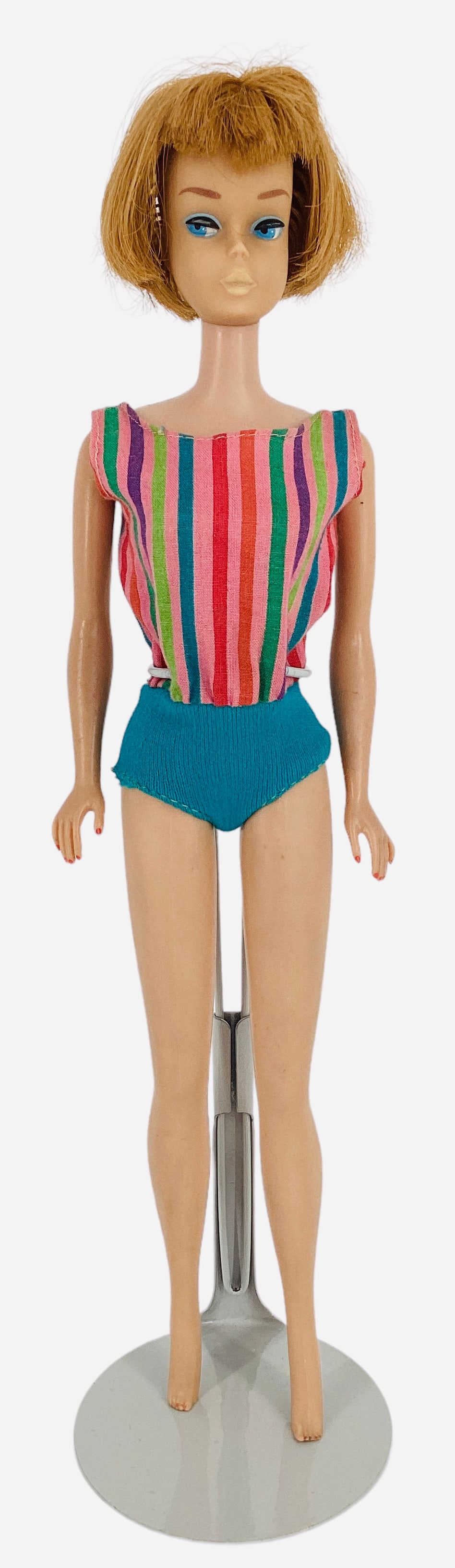 AMERICAN GIRL BARBIE: AMERICAN GIRL BARBIE American Girl Barbie with titan hair, painted fingers and toes and no green ear. Barbie has 1 leg that clicks 3 times and holds and the other leg clicks 2 times. Small mark on bac