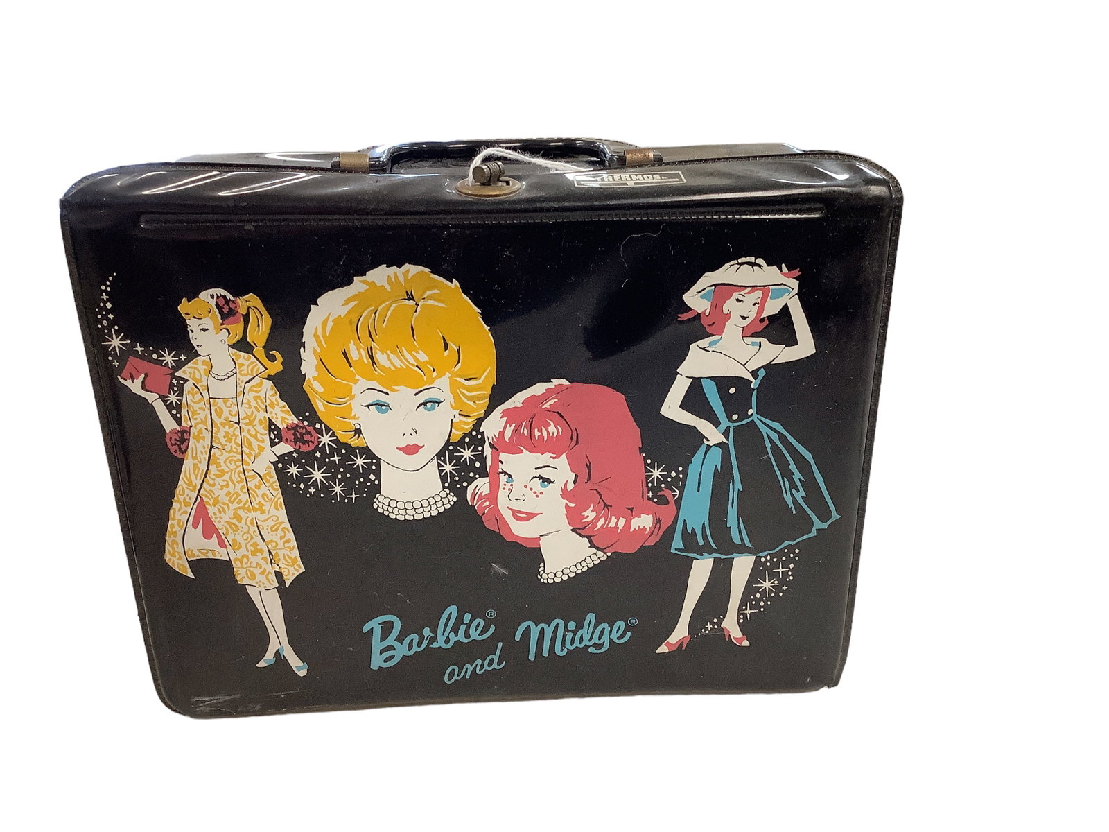 BARBIE AND MIDGE LUNCHBOX: BARBIE AND MIDGE LUNCHBOX Plastic Barbie and Midge lunchbox with graphics of each doll. Also comes with Barbie/Midge lunchbox is a thermos w/graphics of Barbie, Midge and Skipper. The lunchbox has sma