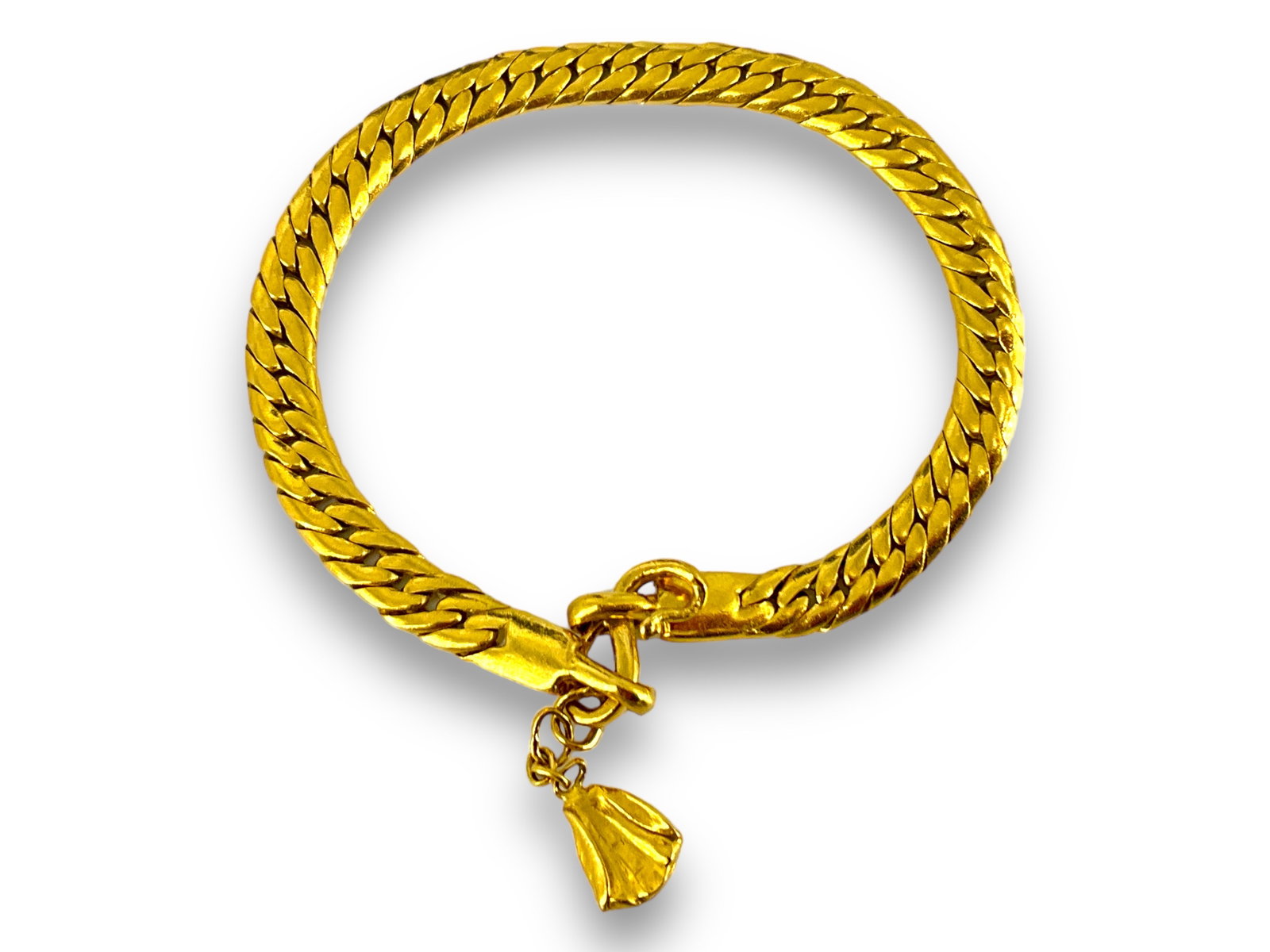 24k Chain Bracelet: 24k Chain Bracelet Bracelet is 6î long, tests as 24k, weighs 18.22 grams and has a charm located at closure. Flat chain is 5.1mm wide.