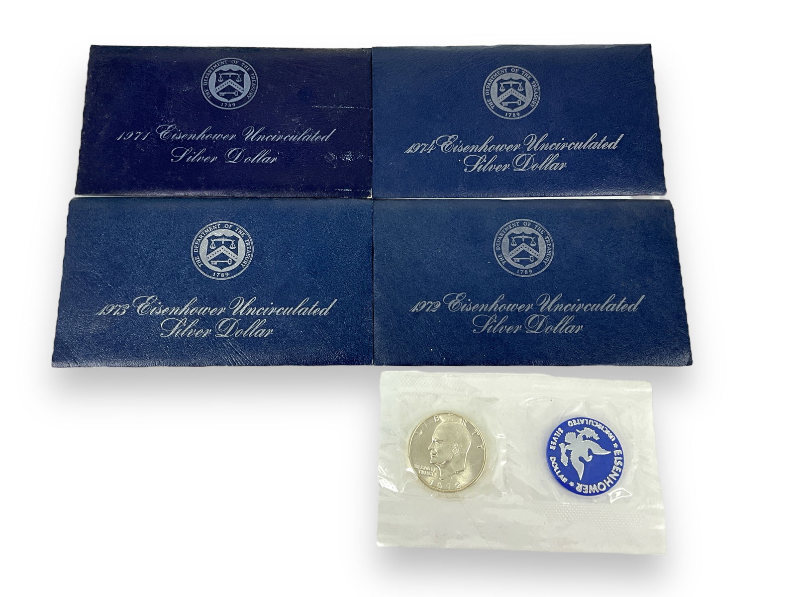 Four Uncirculated Eisenhower Silver Dollar Coins in Envelopes (1 of 5)