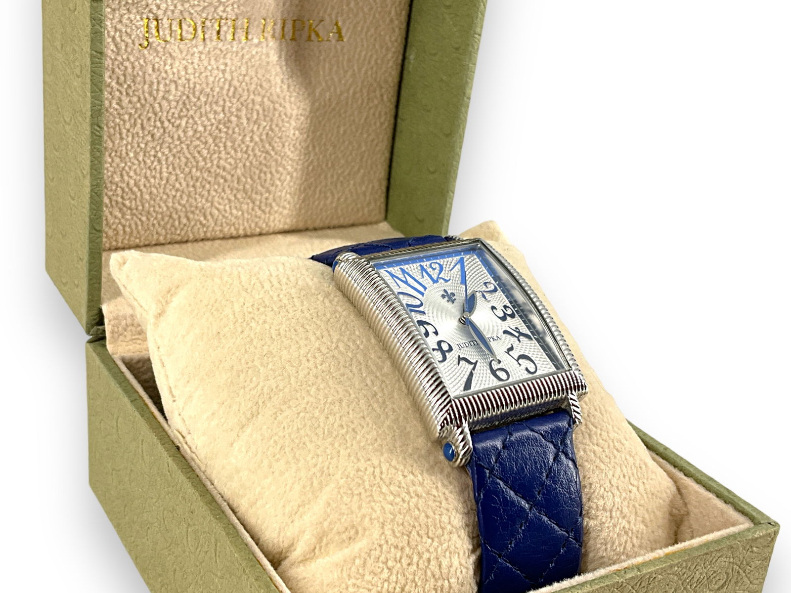 Judith Ripka Wrist Watch: Judith Ripka Wrist Watch Rectangular wrist watch with an engine turned style design on the face, adorned with numbers that stretch to the corners of the watch and are slightly ombrÈ in color, rib