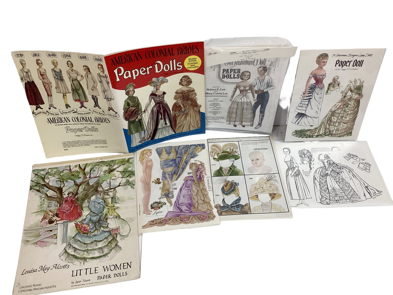 Collection of Uncut Paper Dolls in 1800ís & 1900ís Costumes: Collection of Uncut Paper Dolls in 1800ís & 1900ís Costumes Artists are Peggy Jo Rosamond & Janet Nason. In color & black & white, all are uncut & in excellent condition.