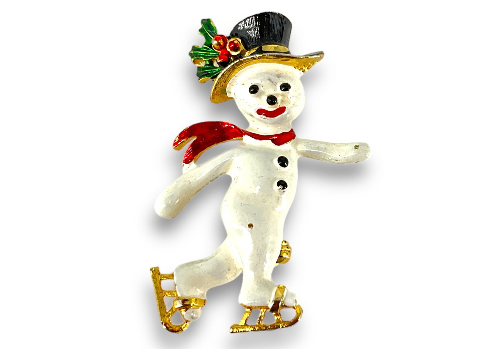 Vintage Snowman Pin: Vintage Snowman Pin Gold tone base medal design measuring approx. (1.61î x 0.98î) featuring a snowman with ice skates and a black top hat with a red scarf, painted design with minimal age re