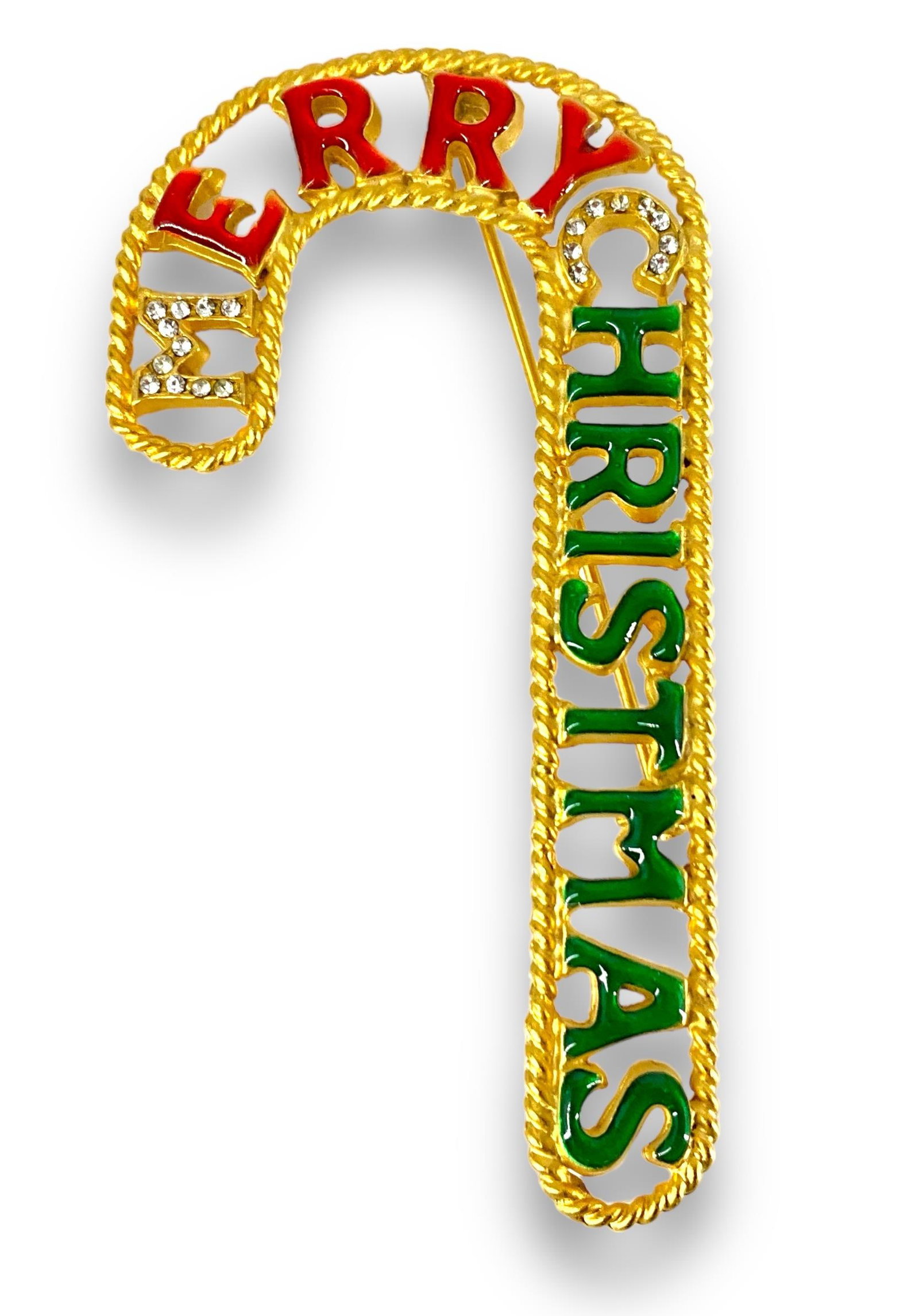 Adorable Vintage Christmas Brooch: Adorable Vintage Christmas Brooch Measuring approx. (3.11î x 1.64î) candy cane motif featuring ìMerry Christmasî with jelly like enamel overlay accented with clear rhinestones on t