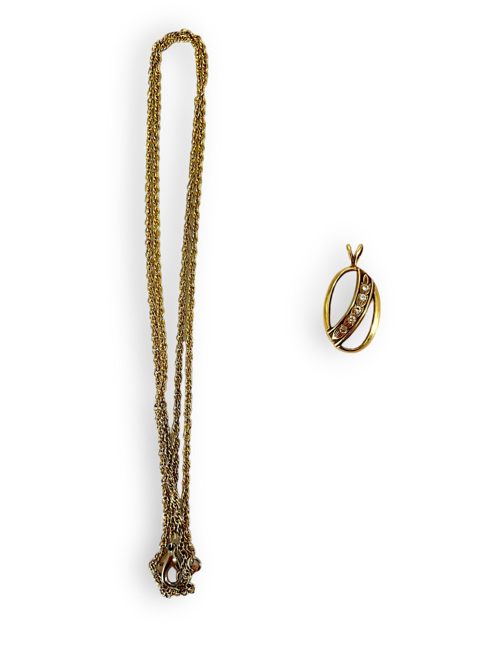 10k Pendant with Diamonds: 10k Pendant with Diamonds Pendant is 1î tall and designed in an open oval shape with a ribbon of 5 tiny melee diamonds, pendant is marked and tested 10k gold and weighs 1.7 grams. There is a non-